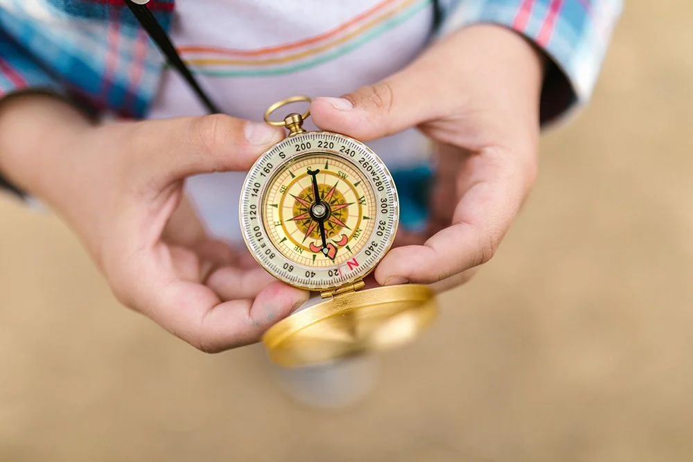 Child holding a compass