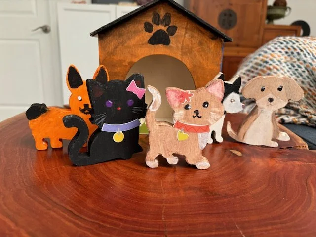 Painted wooden cats and dogs