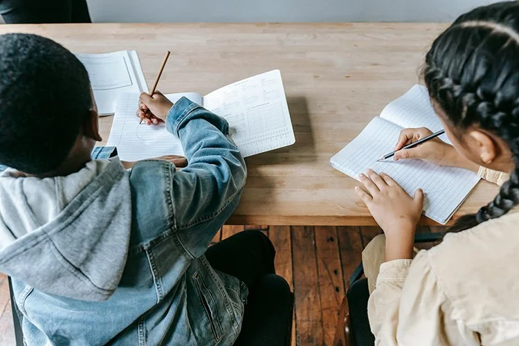 Students writing in notebooks