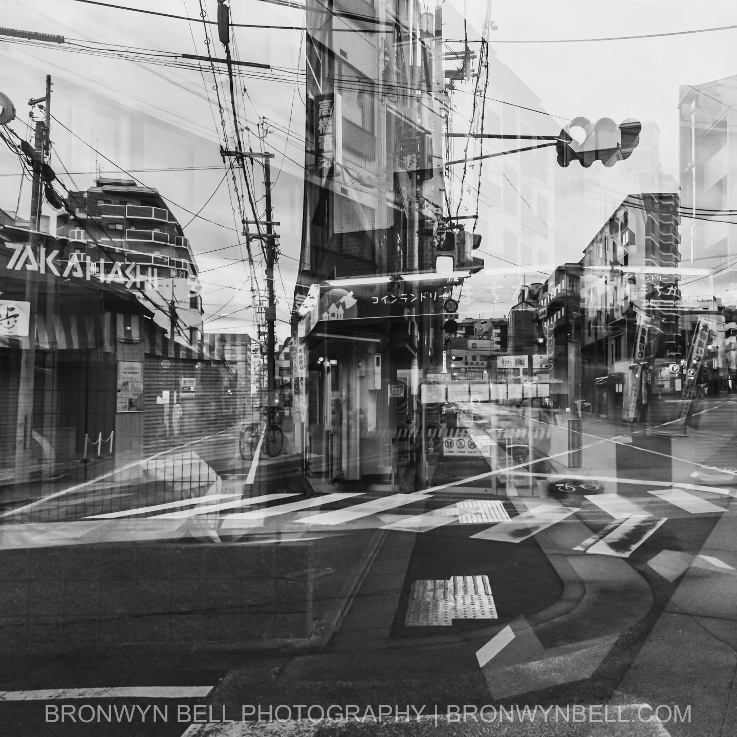 A quiet street rests under the midday sun, its calm broken only by the ghostly double image of a passing bicycle. The layering softens the scene into something remembered, rather than simply seen, evoking Kyoto’s slower rhythms.