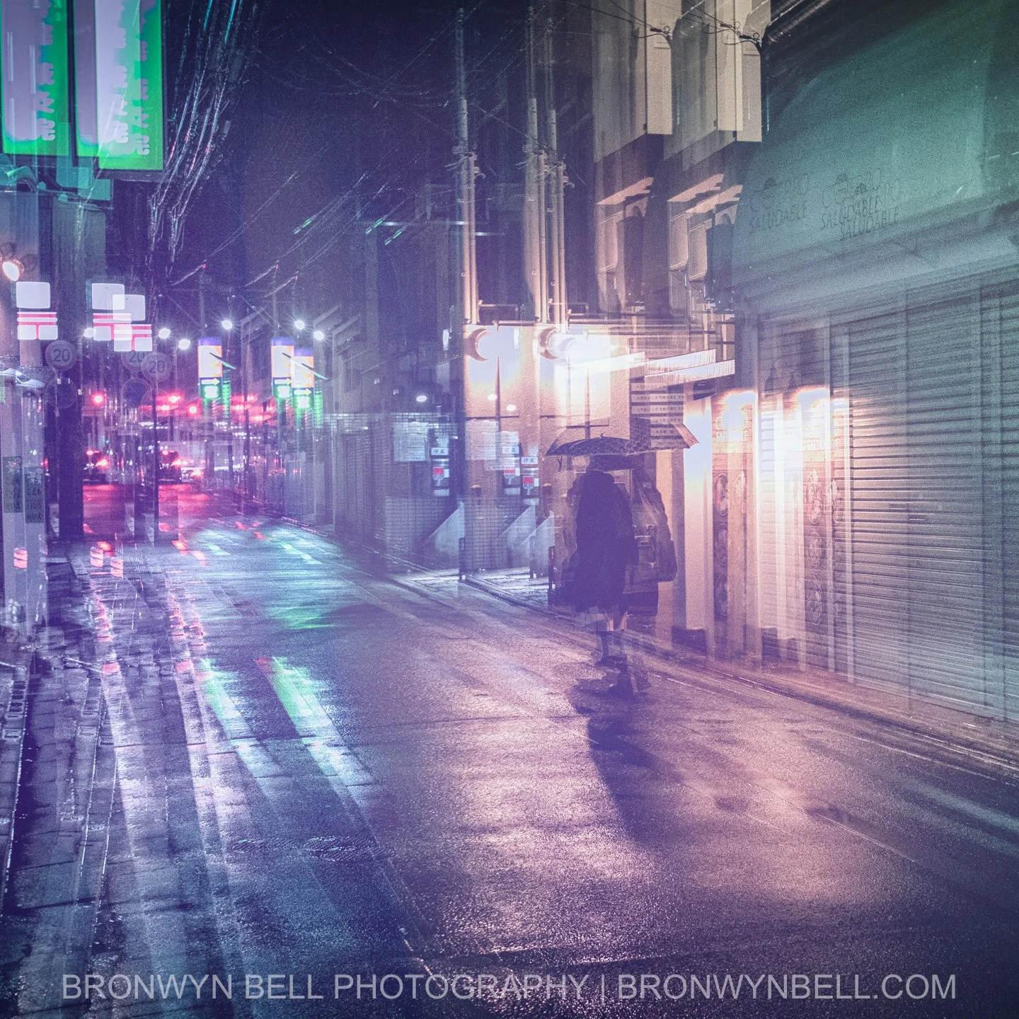 Under the soft haze of rain, Kyoto’s narrow backstreet glows with warm lantern light, the wet road shimmering like glass. Multi-exposures layer passing bicycles, blurred footsteps, and faint reflections, creating a scene that feels both fleeting and 