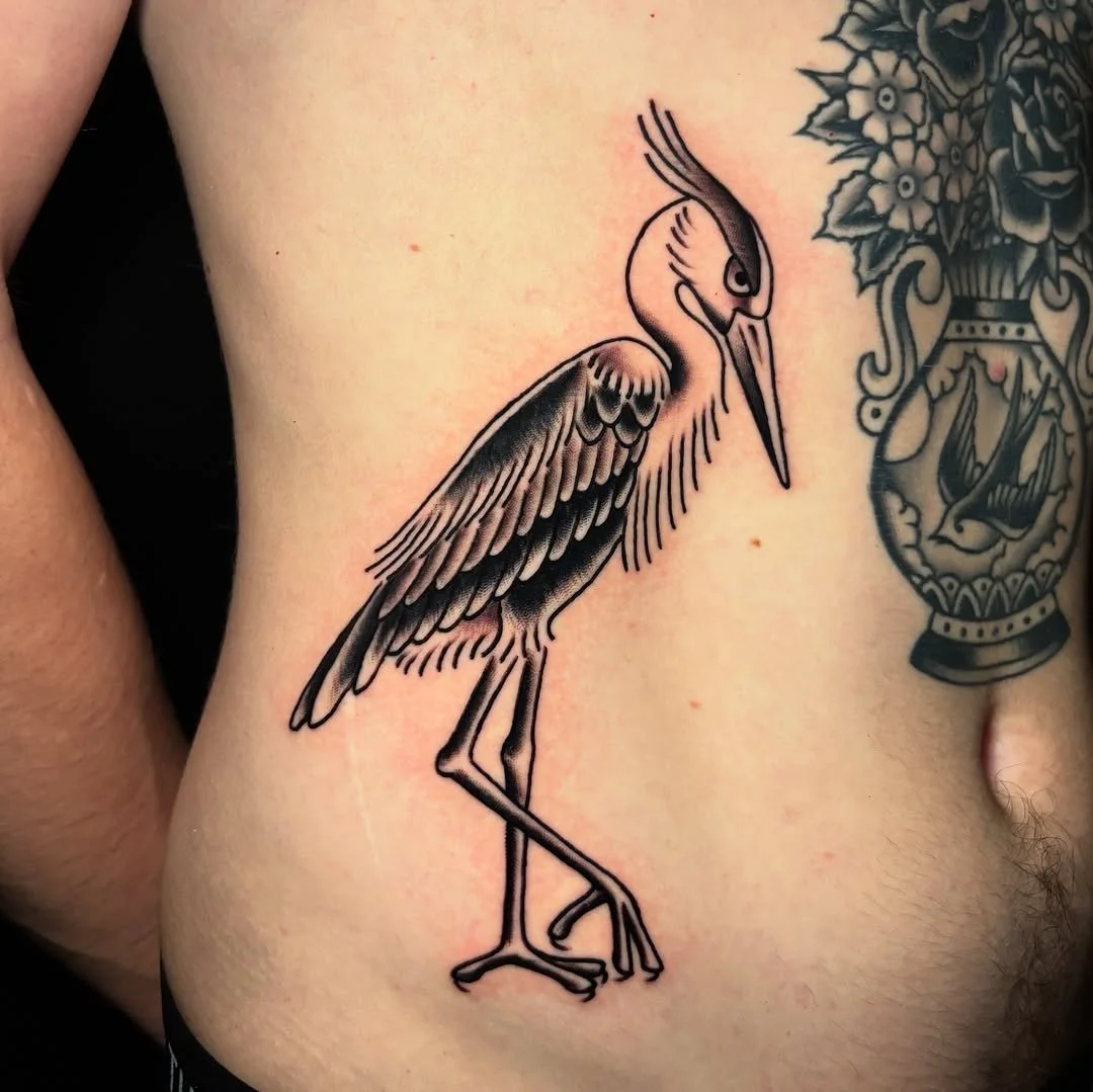 Michel Parisay - @michelparisay is tattooing at @inkanddaggertattoo give them a follow! - fresh heron, and a couple of healed ones on Chase. &bull; booking link in my bio, flash always available! &bull;  #traditionaltattoo #blacktraditionaltattoo #he