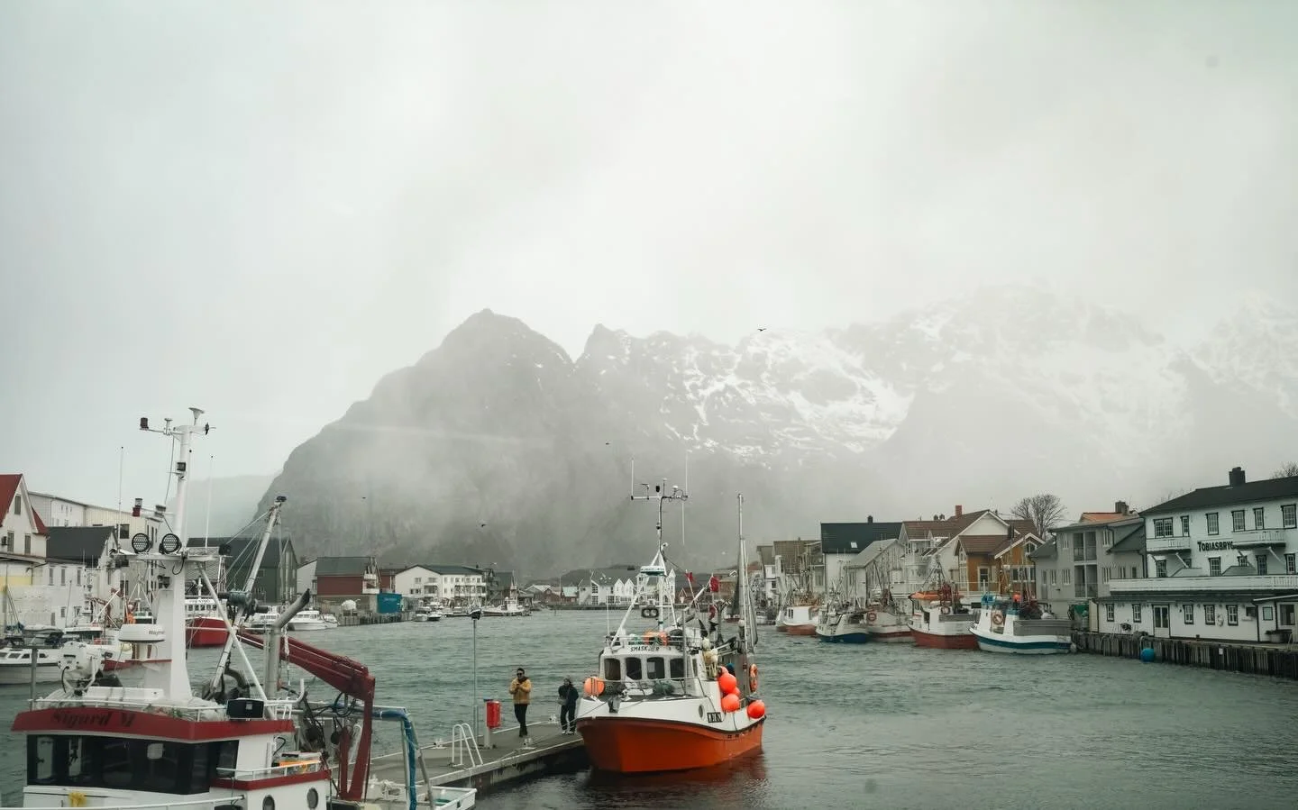 Arctic April - The Arctic never arrives the same way twice. Some days it offers calm, others it leans into something harsher. In Henningsvaer, its fishing village holds its stillnes, while behind it, an Arctic storm arrives with winds rising beyond w