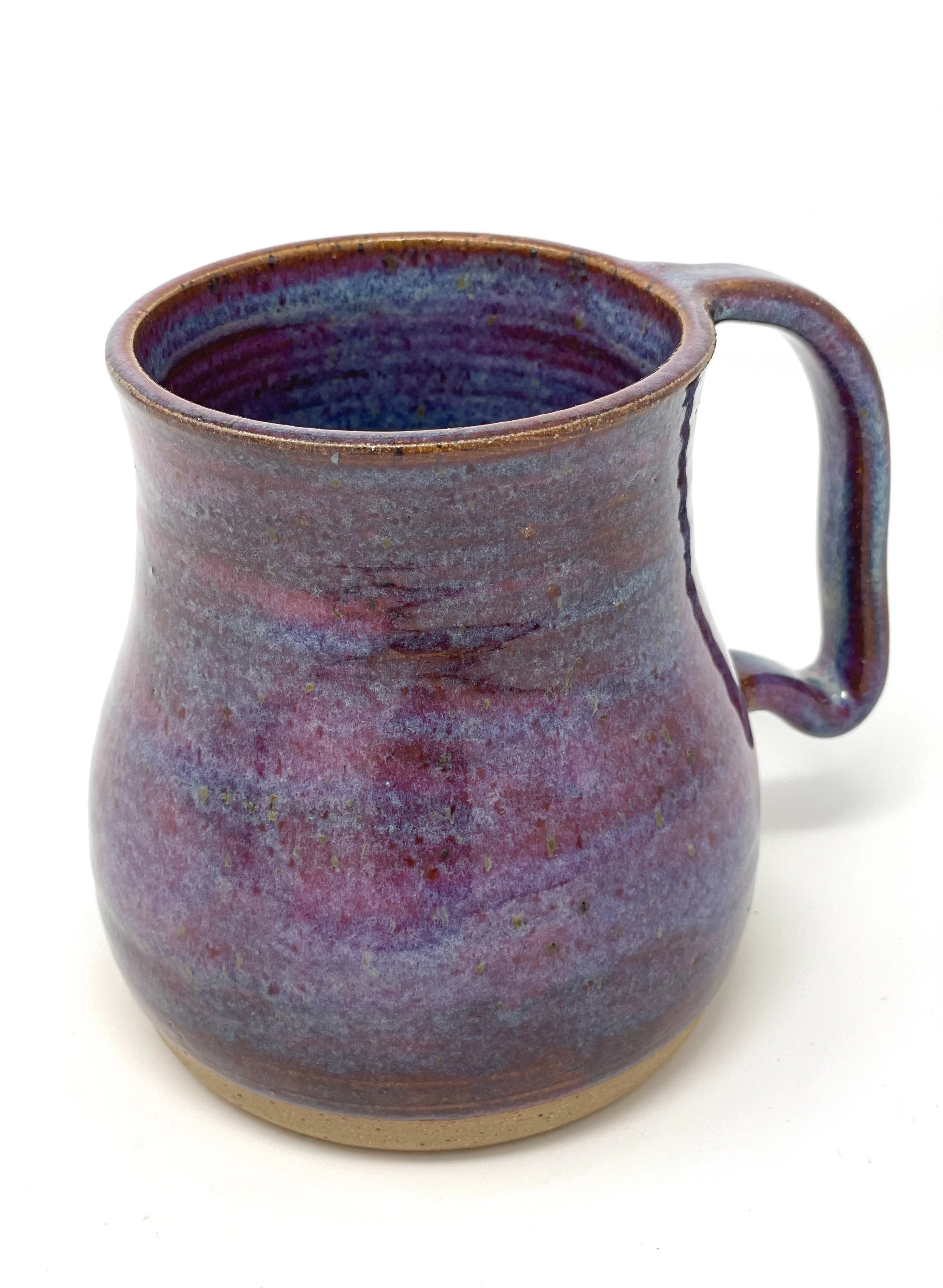 A colorful ceramic mug with a purple, pink, and blue glaze on a white background.