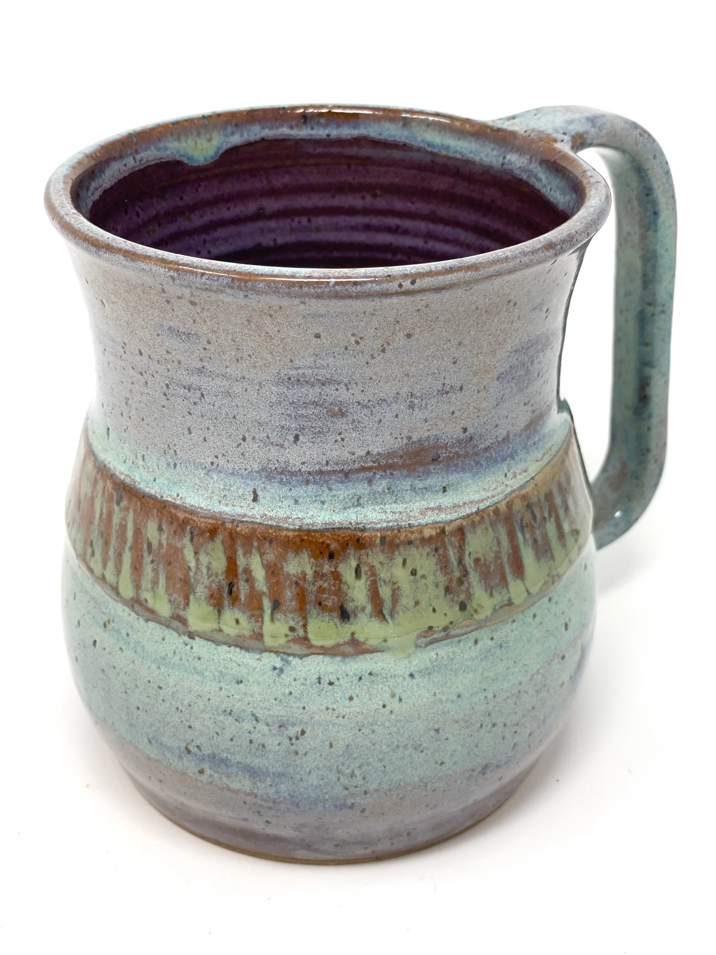 A ceramic mug with a round body, a lid, and a handle, featuring a multicolored glaze with blue, green, purple, and brown hues.