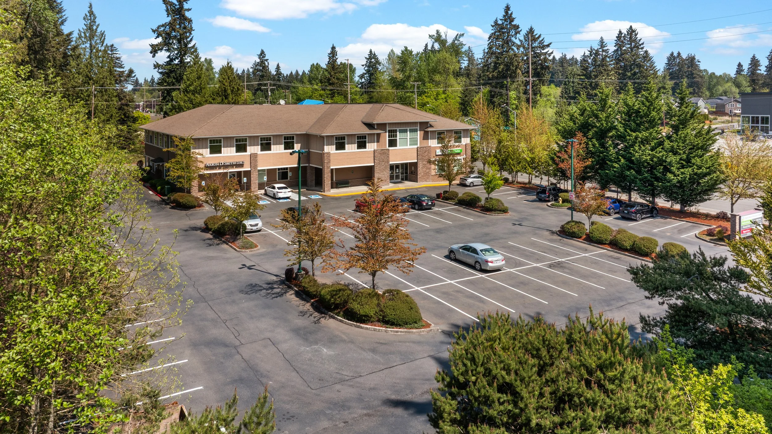Aerial view of the Franciscan Medical Clinic building with on-site parking, landscaped grounds, and convenient patient access in Puyallup, Washington.