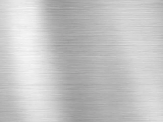 Close-up of a metallic brushed aluminum surface with horizontal lines.