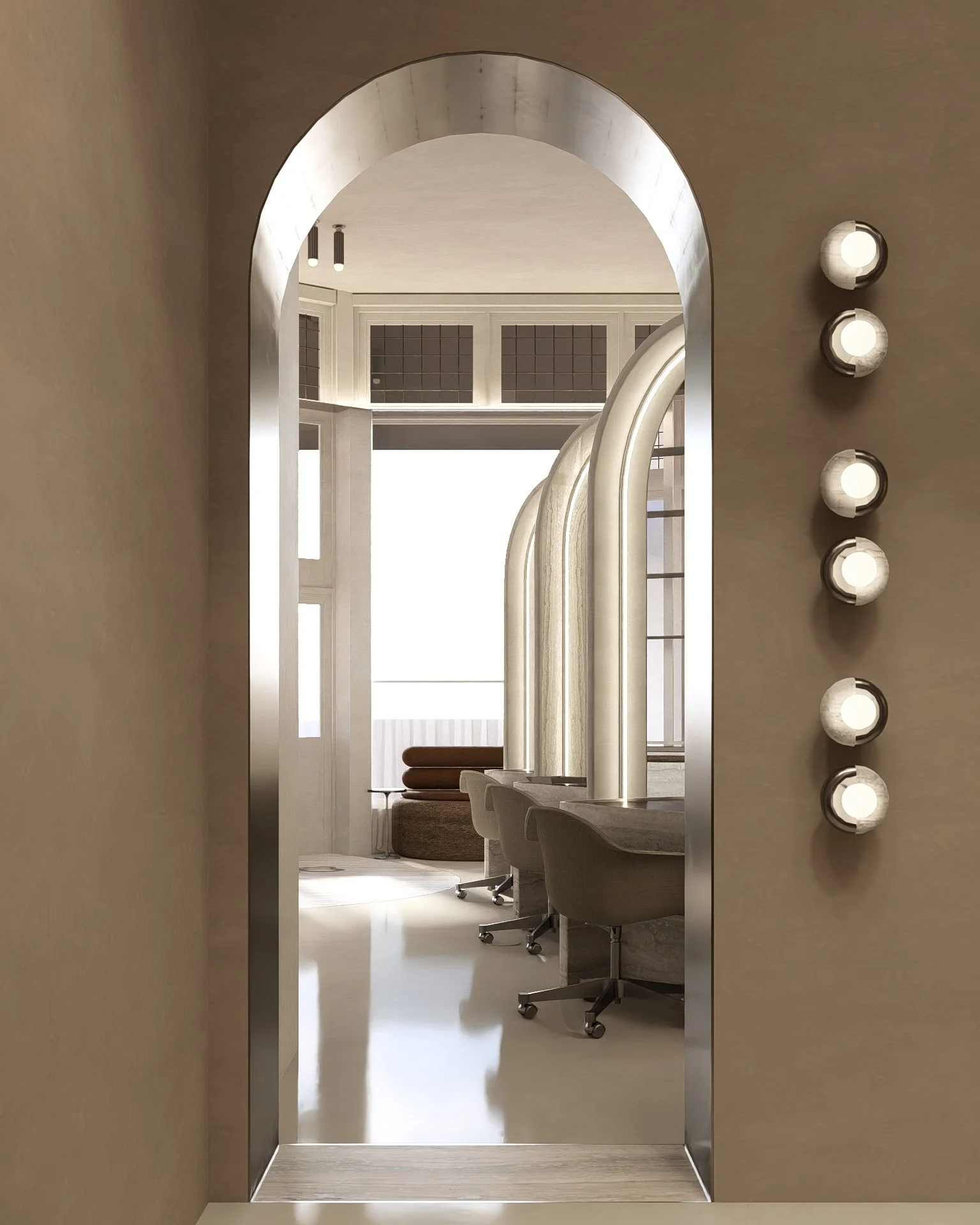 A modern office space with a row of beige office chairs, a large window, and a seating area with a brown sofa visible through an open archway under a white ceiling with hanging lights.