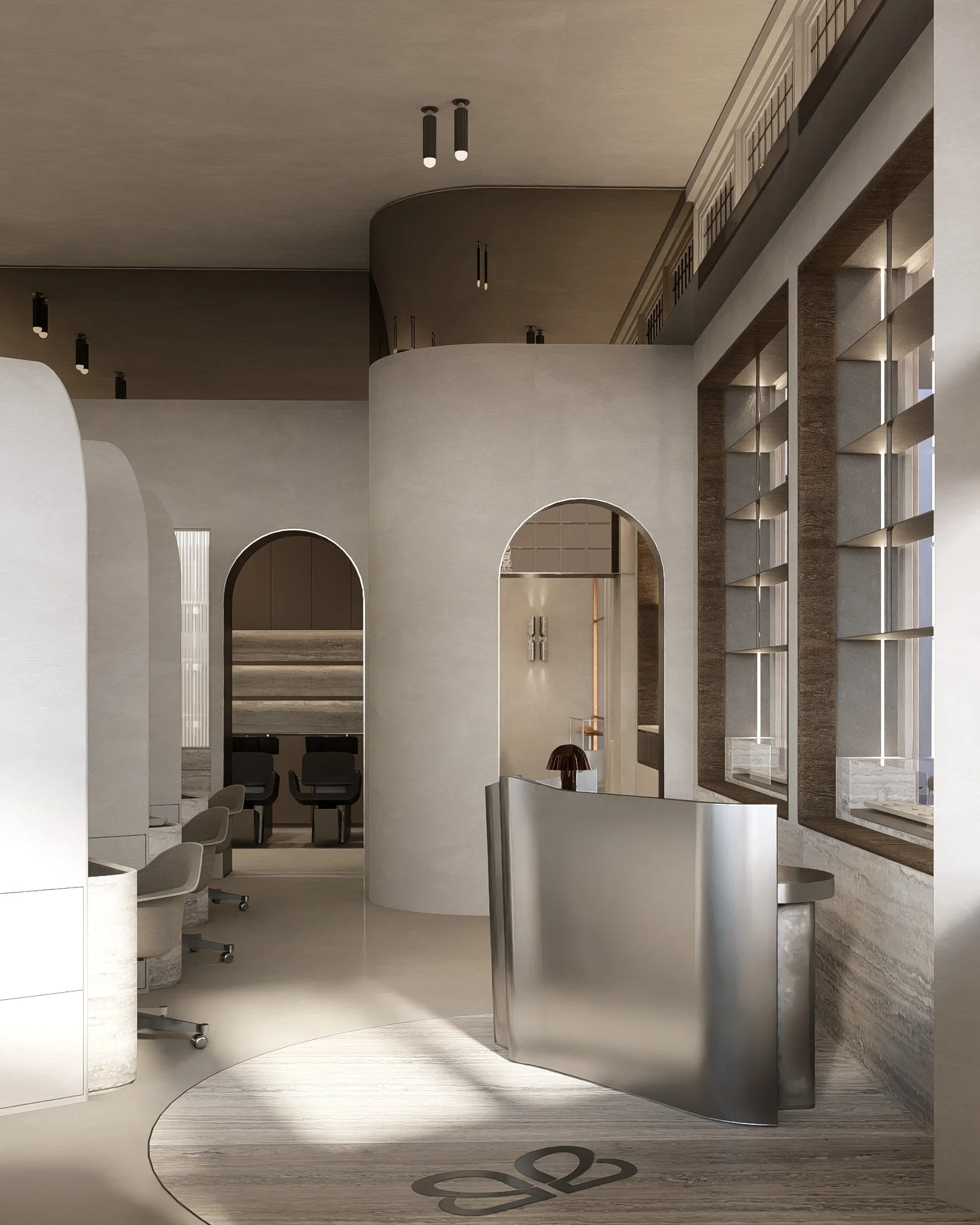 Modern interior space with curved white walls, a metallic reception desk, large windows with wooden frames, and a beige ceiling with black light fixtures.