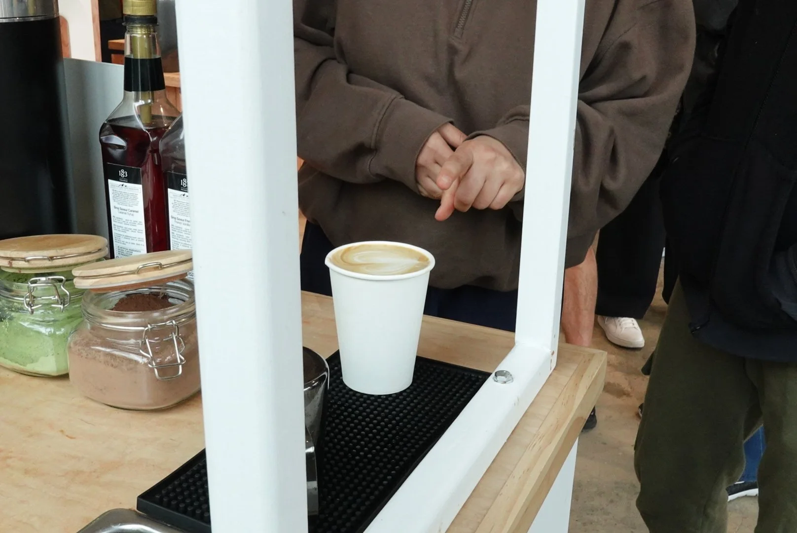 mobile barista giving a latte art latte to a guest