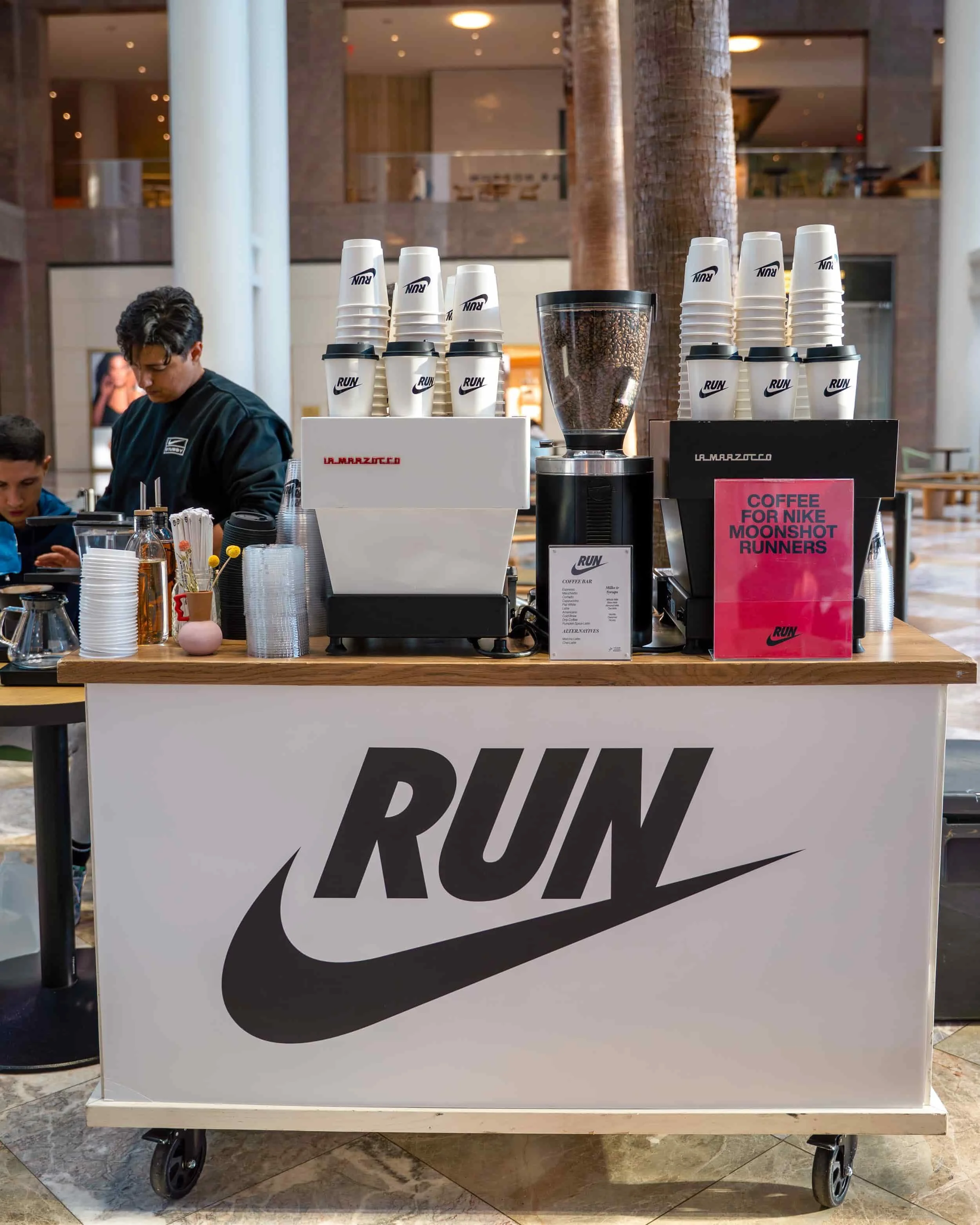 Barista serving handcrafted espresso drinks from a mobile coffee cart
