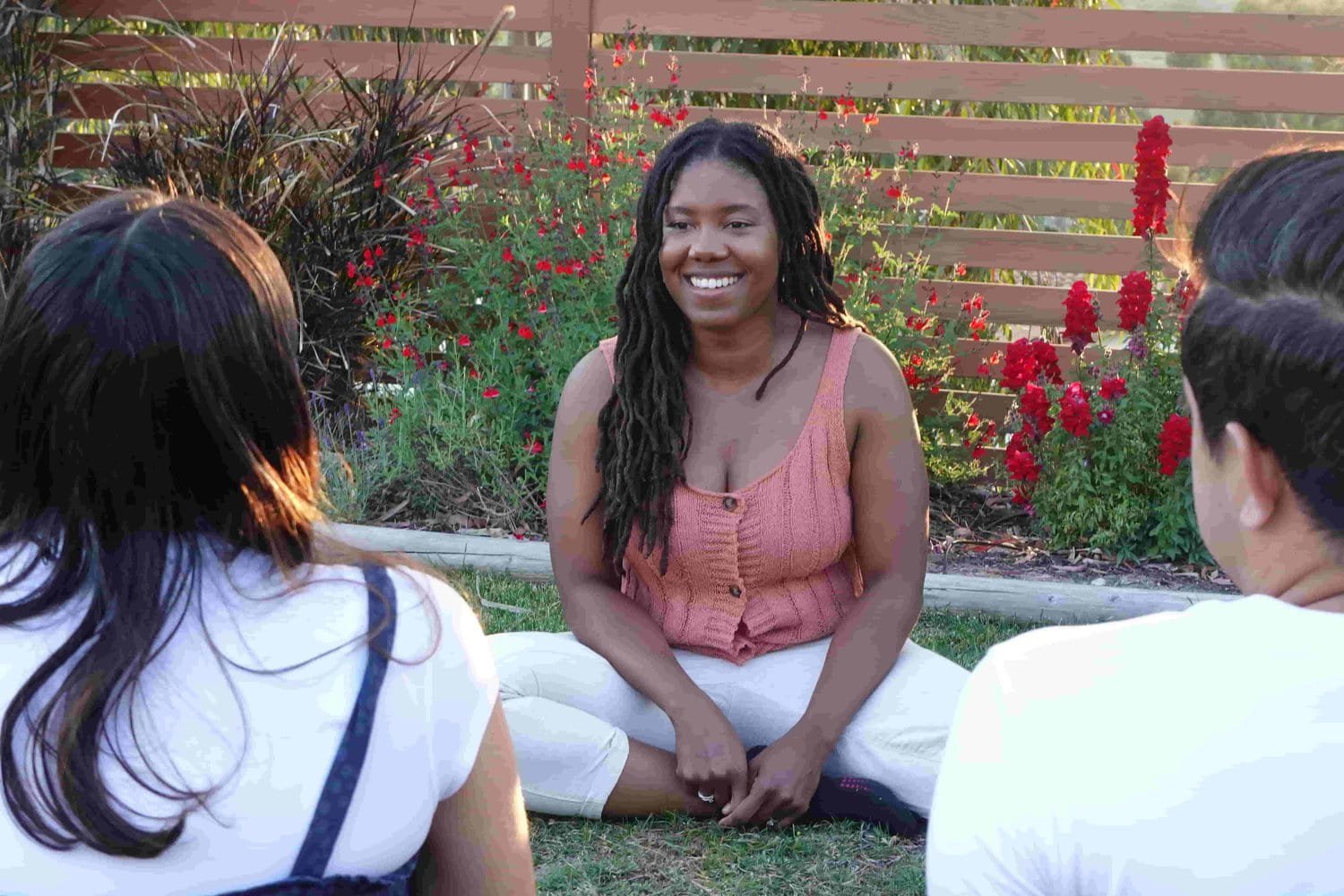 Black Woman Smiling with Couple Outdoors