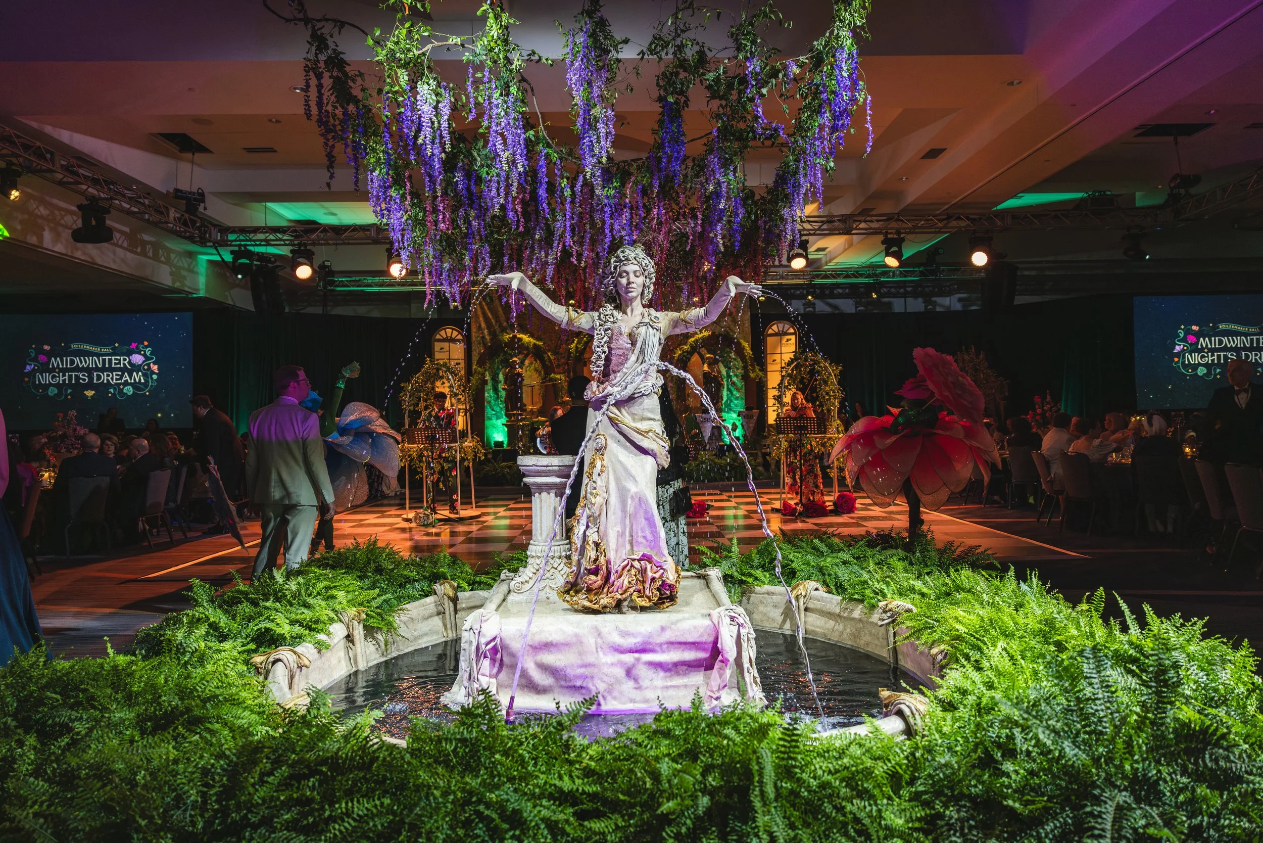 Fountain centerpiece and wisteria canopy installation at the 2026 Purdue Boilermaker Ball, an enchanted garden themed black-tie fundraising event for Purdue for Life Foundation.