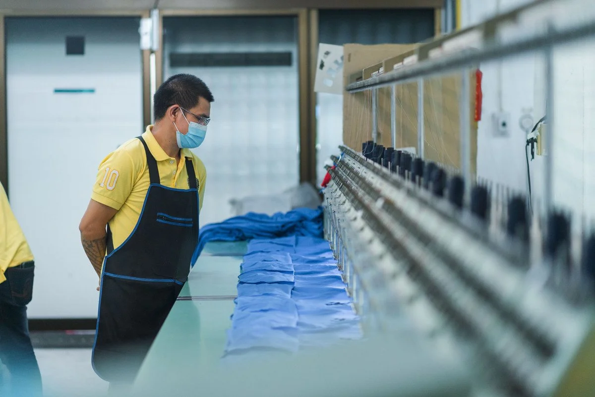 Staff operating embroidery machine