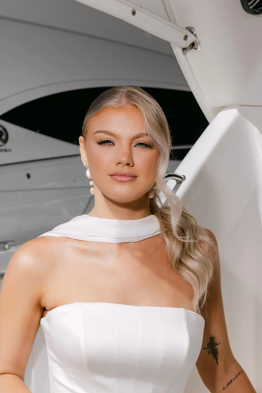 Editorial close-up of bridal model with soft light makeup and modern wedding styling