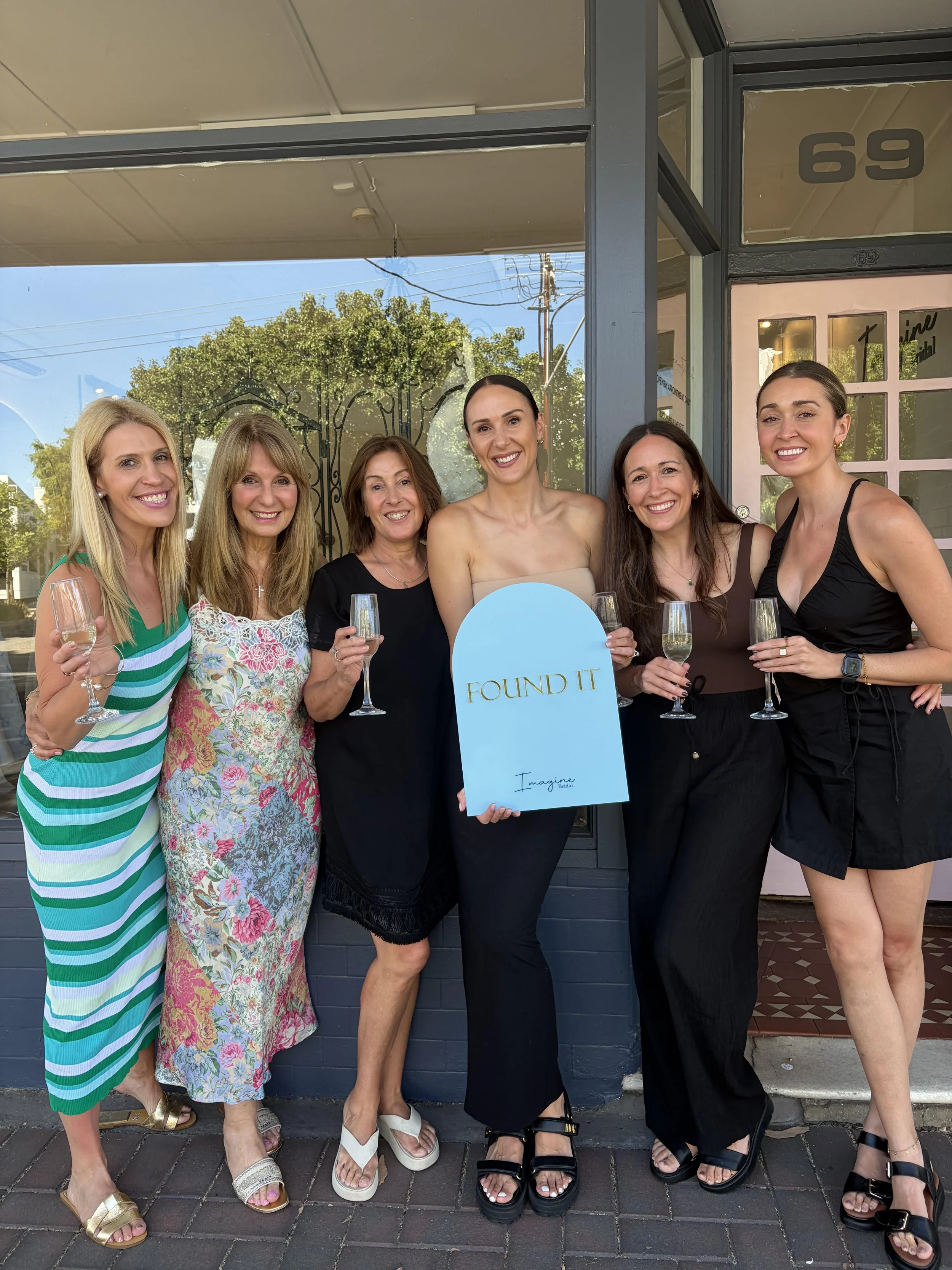 Adelaide bride celebrating with her bridal party outside Imagine Bridal after saying yes to her designer wedding dress.