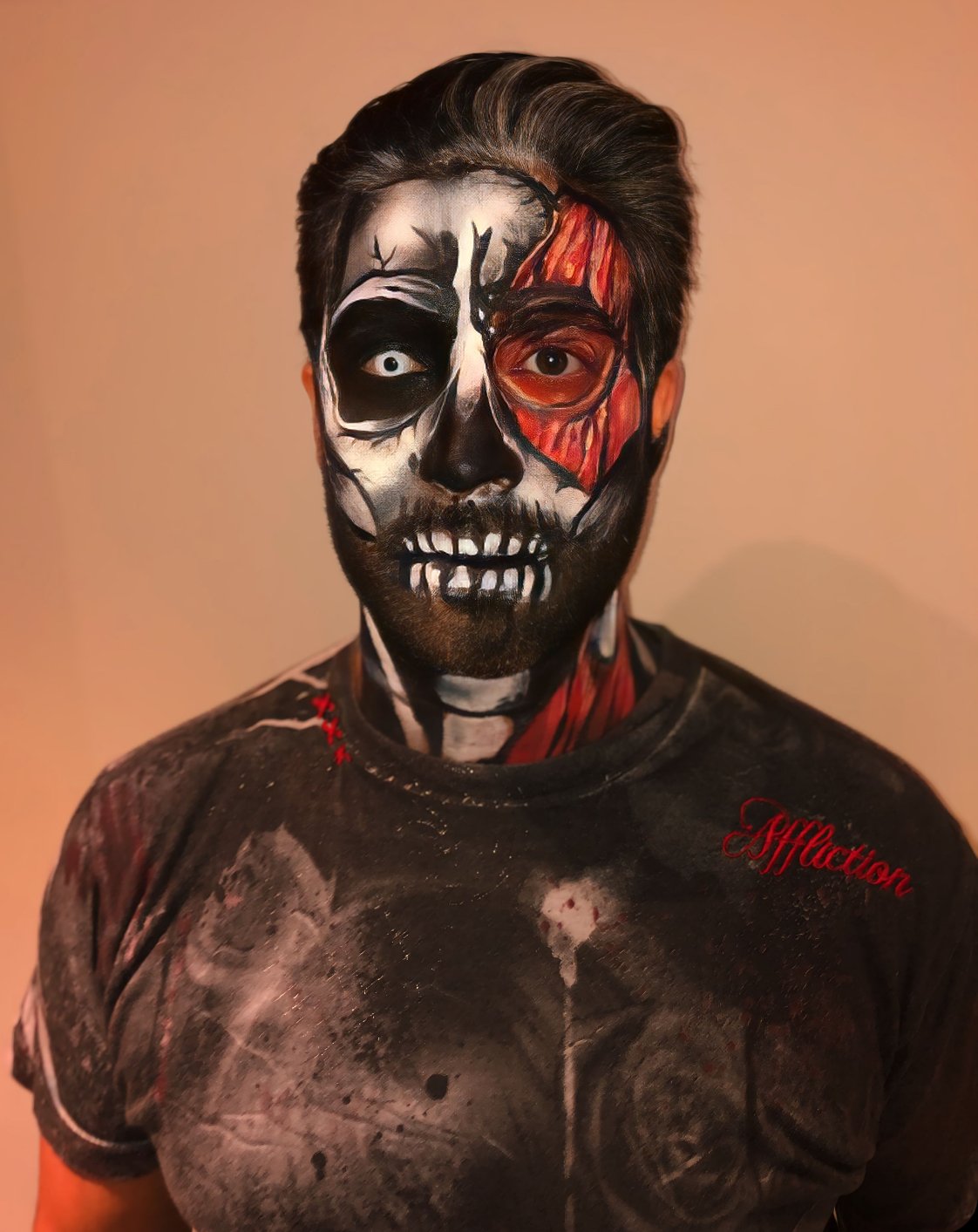 The photo showcases a striking Halloween look with an exposed skull and muscle design, skillfully crafted by Suhaila. The realistic details and dramatic contrasts create a hauntingly impressive effect.