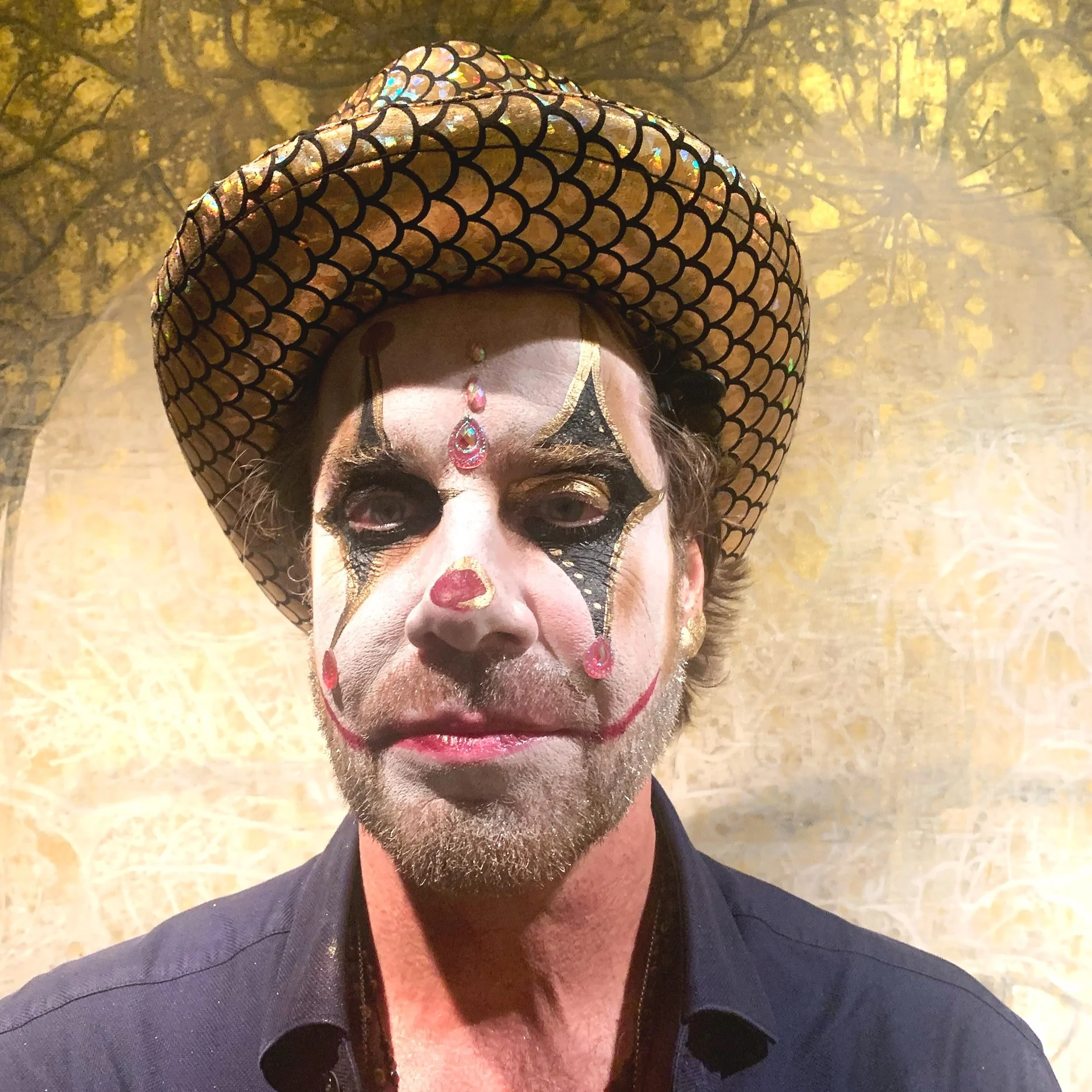 The photo presents a bold Halloween look with a pimp clown theme, expertly designed by Suhaila. The striking makeup combines vibrant colors and intricate details to create a memorable and eccentric appearance.