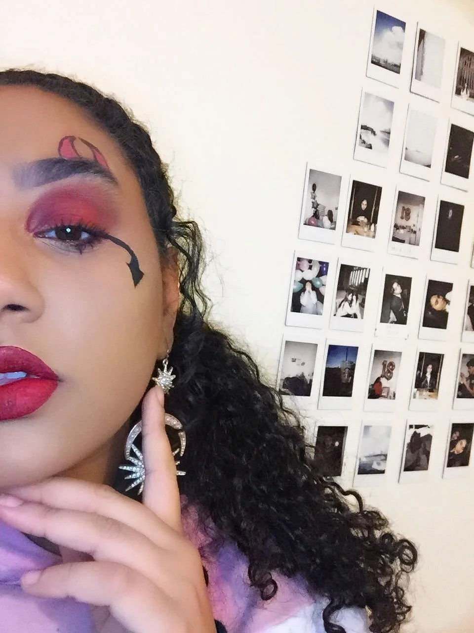 The photo features a glamorous "She Devil" look, with striking Lilith-inspired makeup by Suhaila Ali. The design combines fierce elegance with devilish charm, creating a bold and captivating appearance.