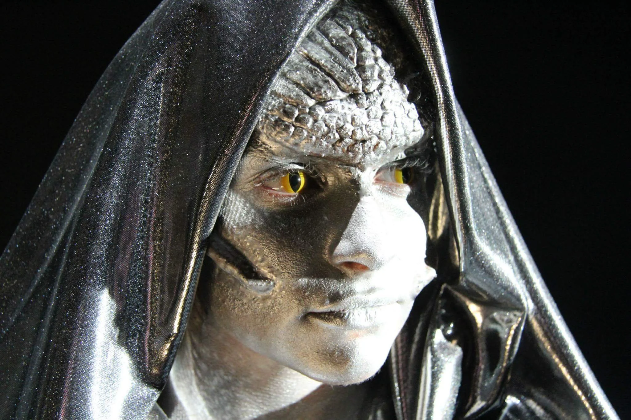 The photo features an exceptional Medusa cosplay with special effects makeup by Suhaila, including intricate prosthetics, striking contact lenses, and shimmering silver accents. The combination creates a hauntingly realistic and captivating Halloween