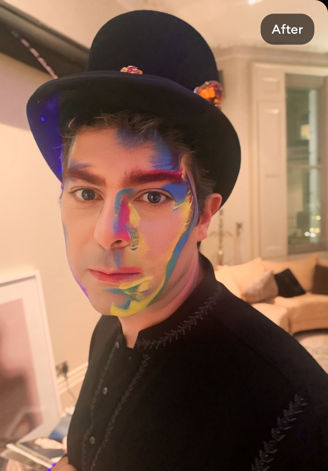 The photo features an avant-garde Halloween look with a watercolor rainbow theme, masterfully created by Suhaila. The unique makeup blends vibrant hues and artistic brushstrokes for a truly eye-catching and innovative effect.