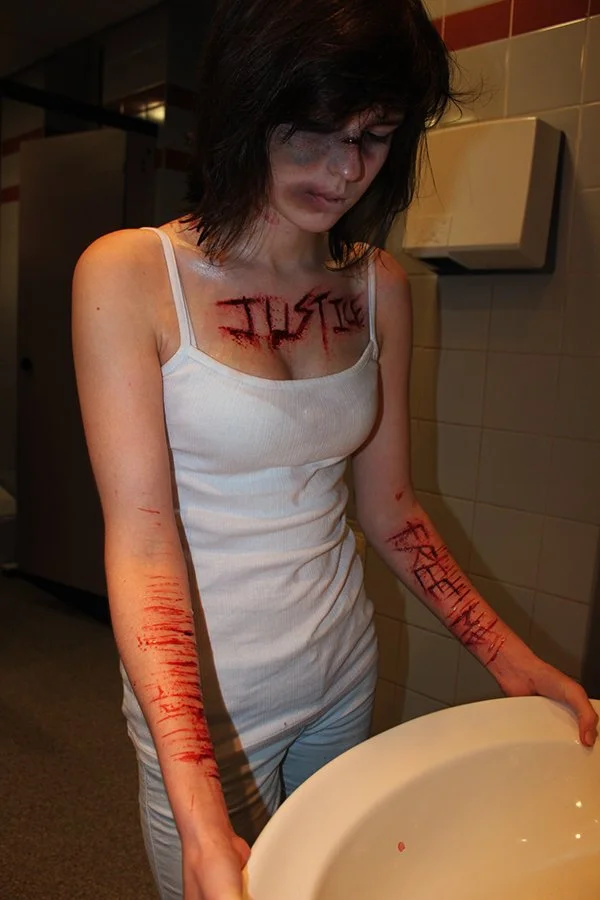 The photo features intense scar and cut makeup from *The Knowing*, expertly created by Suhaila. The special effects capture a hauntingly realistic portrayal of injury and trauma with exceptional detail.