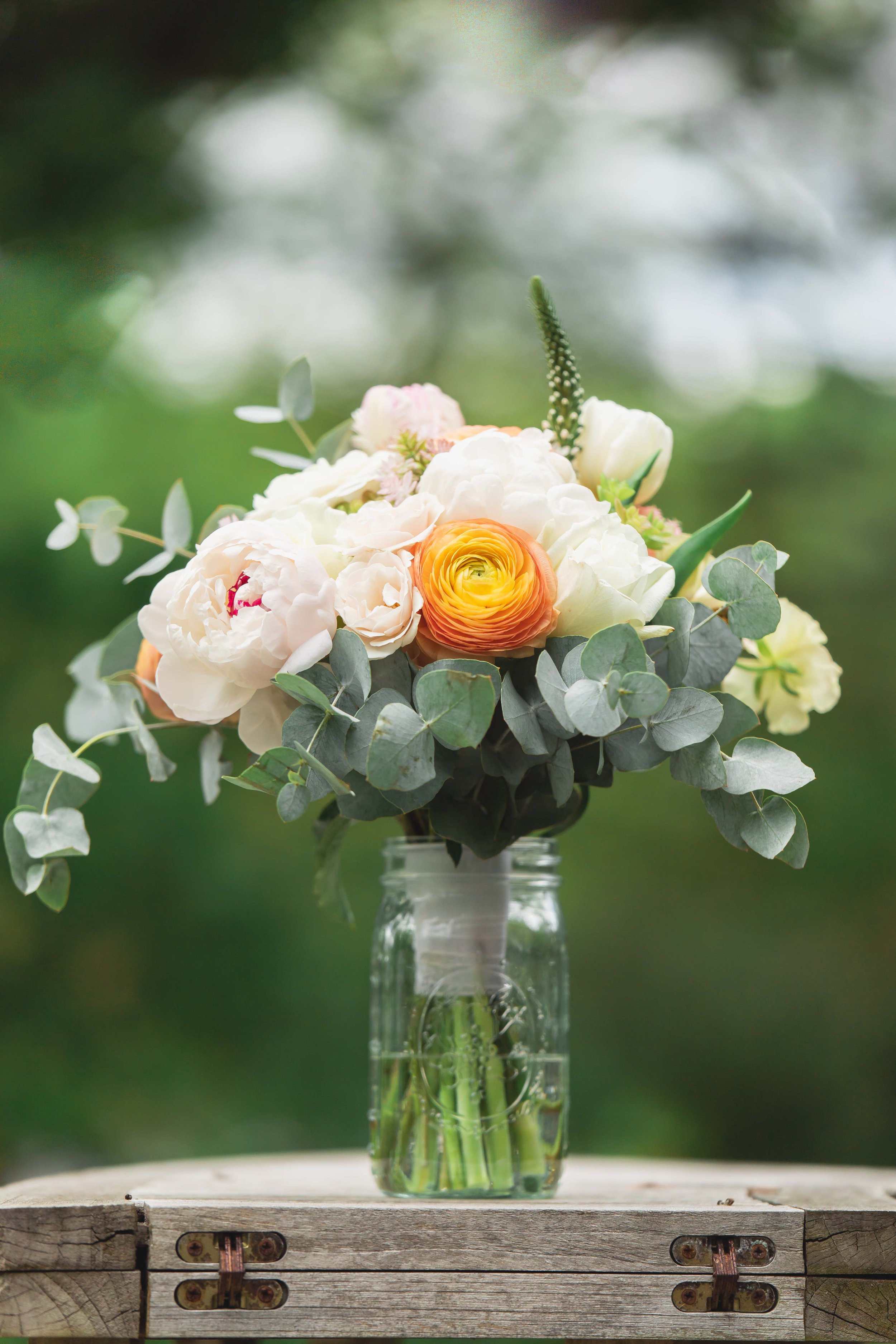 bridal bouquet of flowers in ball jar outside bridal suite at Saugerties Performing Arts Factory wedding venue in upstate NY