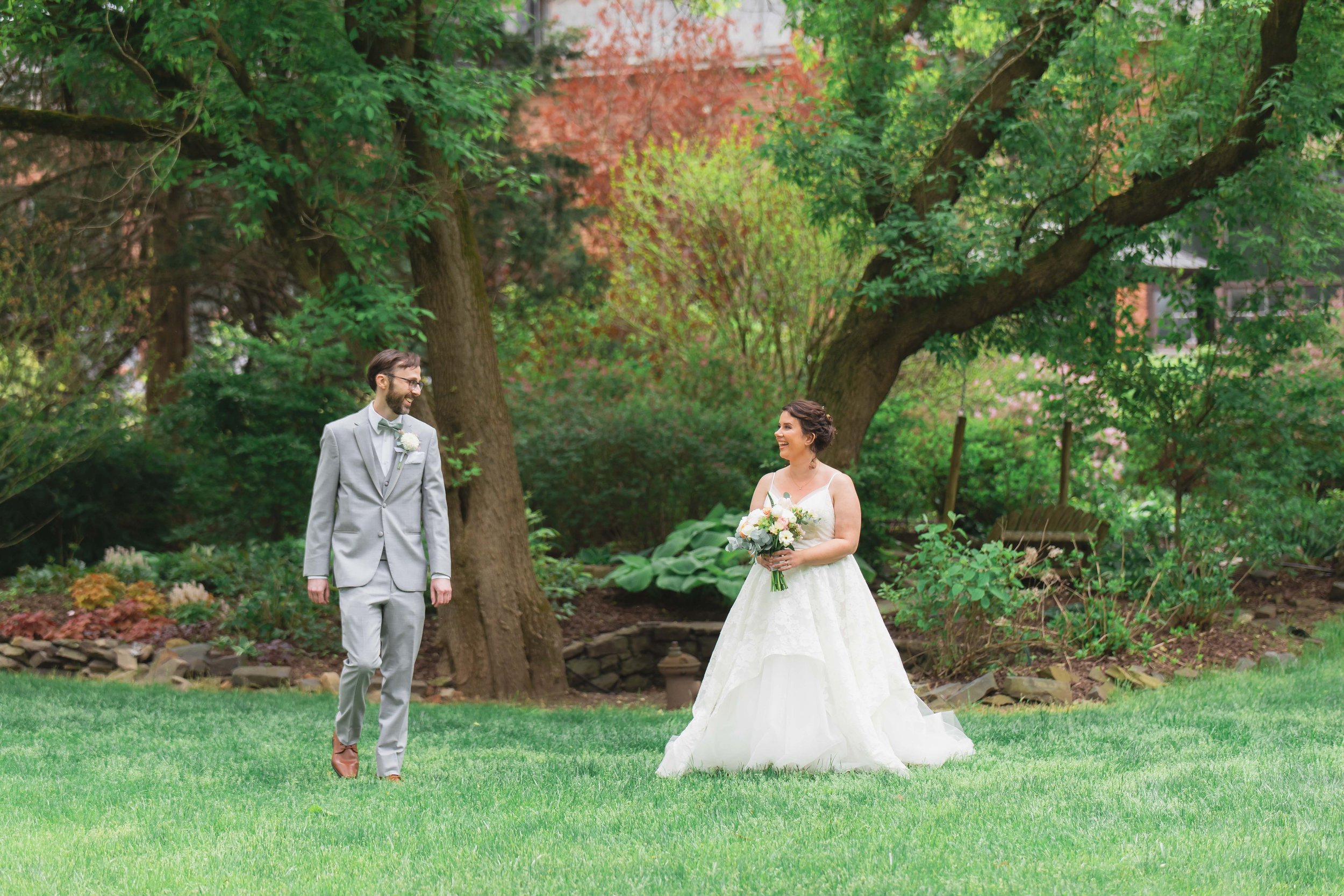 Bride and groom first look in garden in summer at Saugerties Performing Arts Factory wedding venue in upstate NY