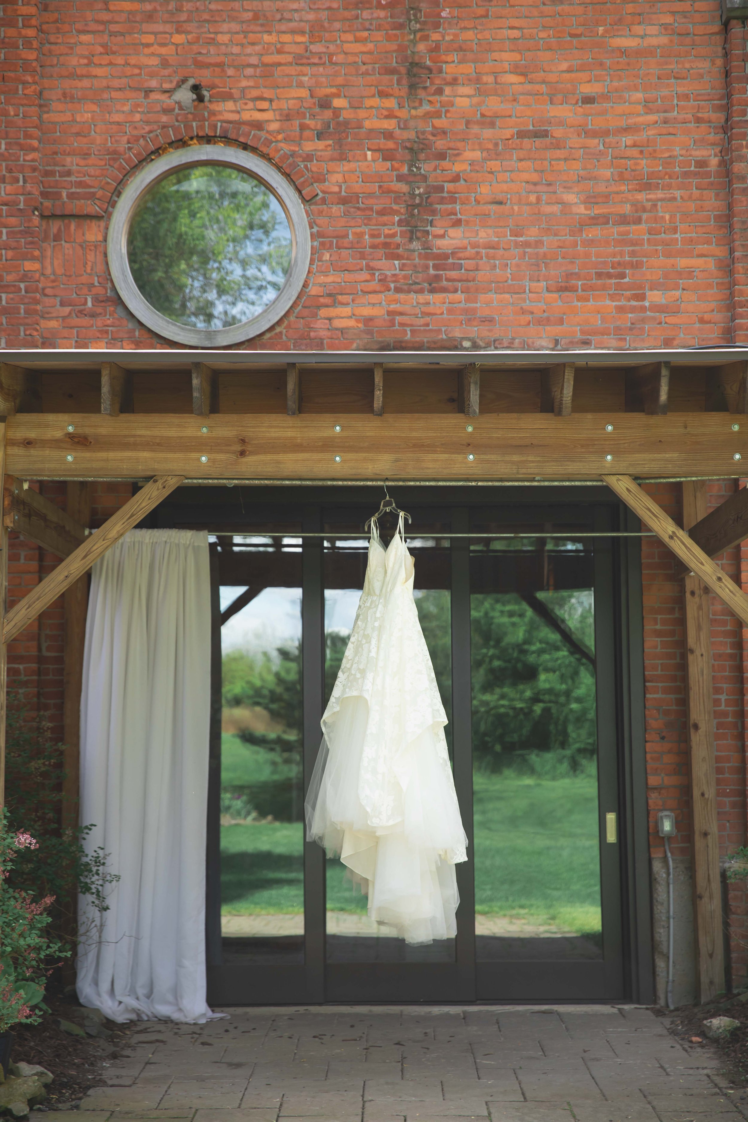 wedding dress hanging outside bridal suite at Saugerties Performing Arts Factory wedding venue in upstate NY