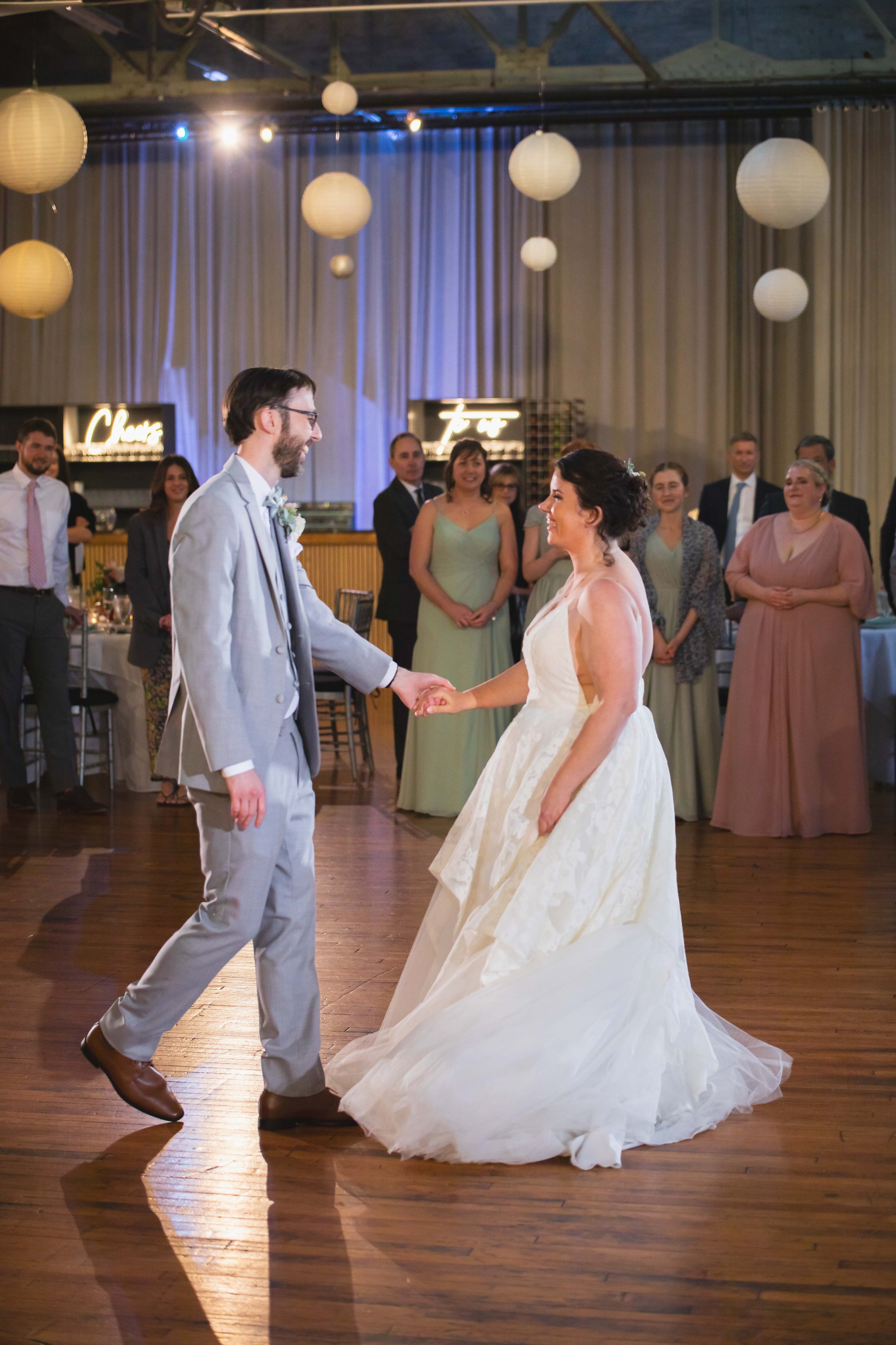 bride and groom first dance in front of wedding party at reception at Saugerties Performing Arts Factory chic industrial wedding venue in upstate NY