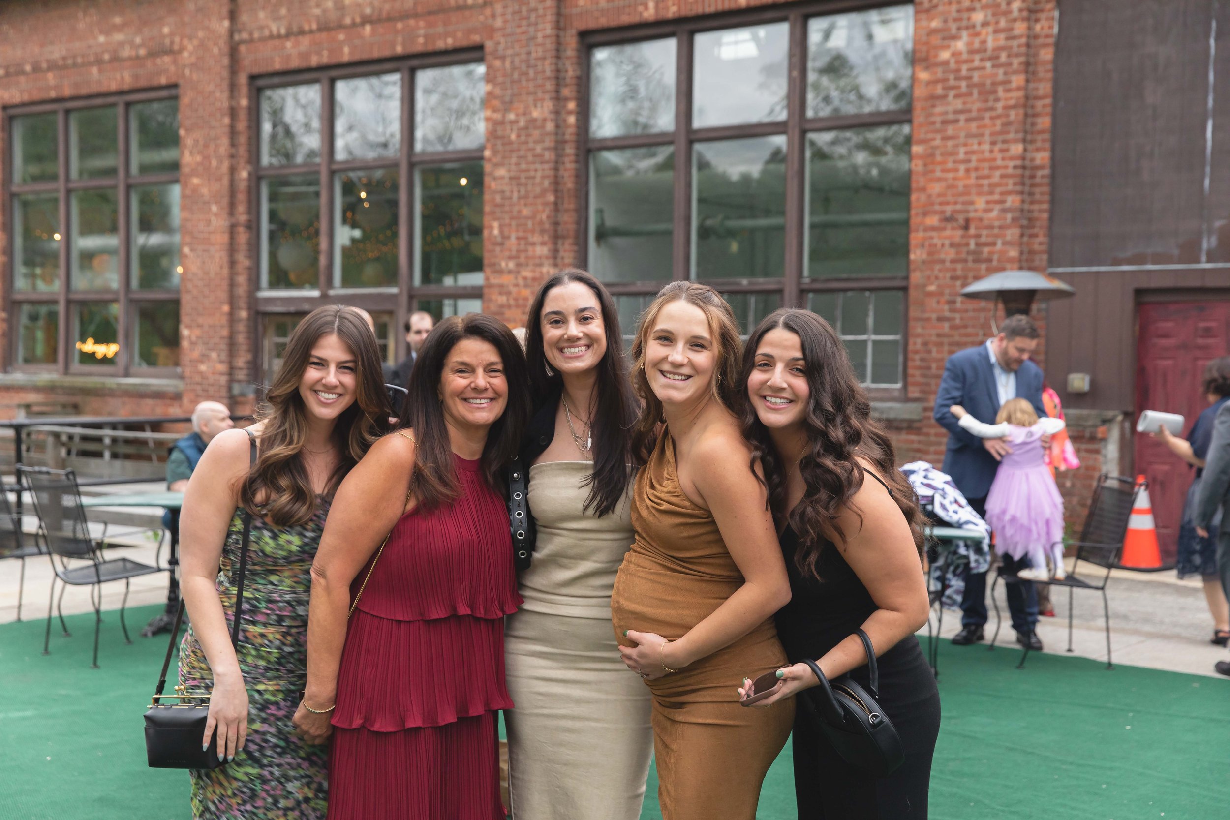wedding guests smile on patio after ceremony at Saugerties Performing Arts Factory chic industrial wedding venue in upstate NY
