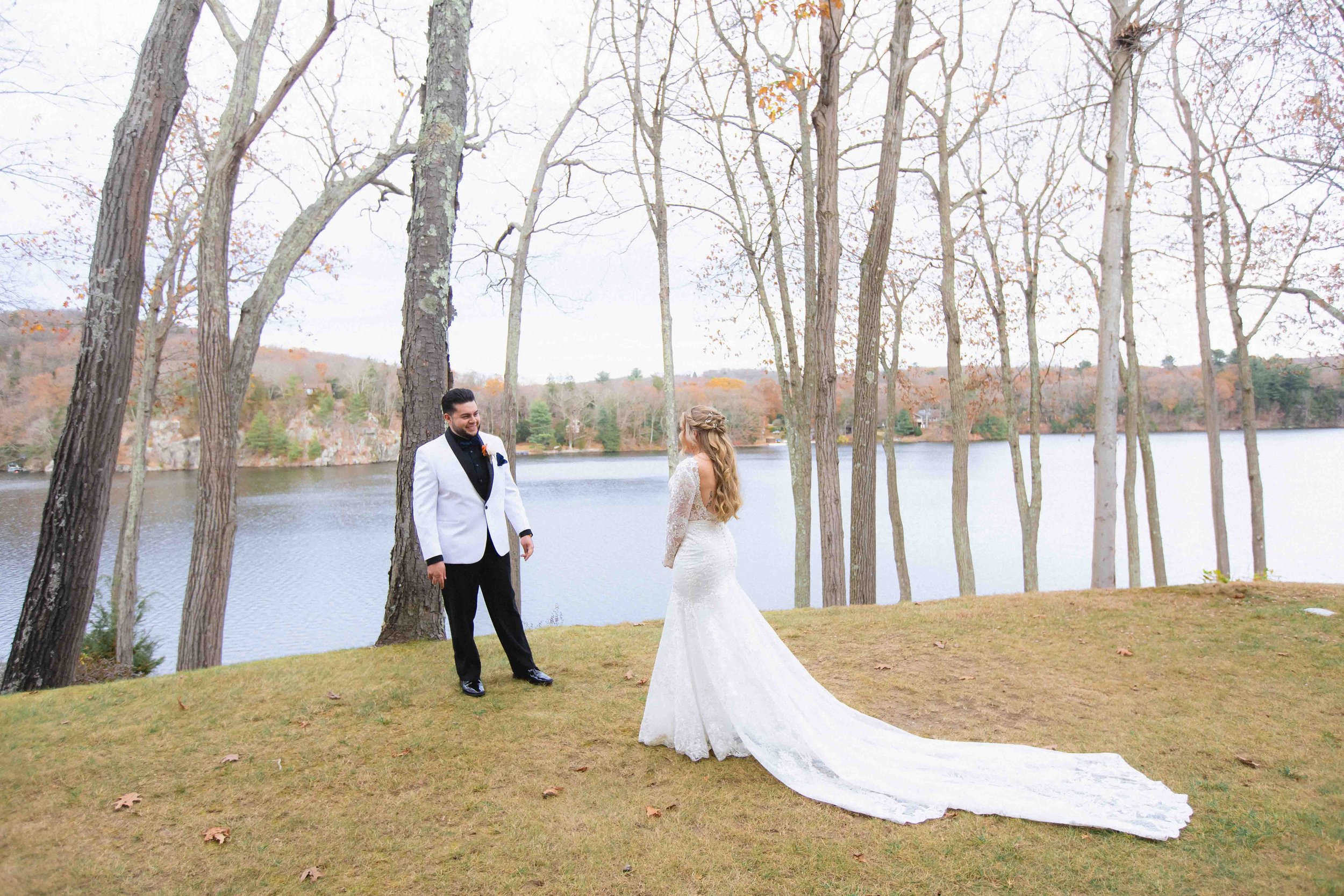 bride and groom have a first lakeside above the water at at the waterview wedding venue in monroe ct