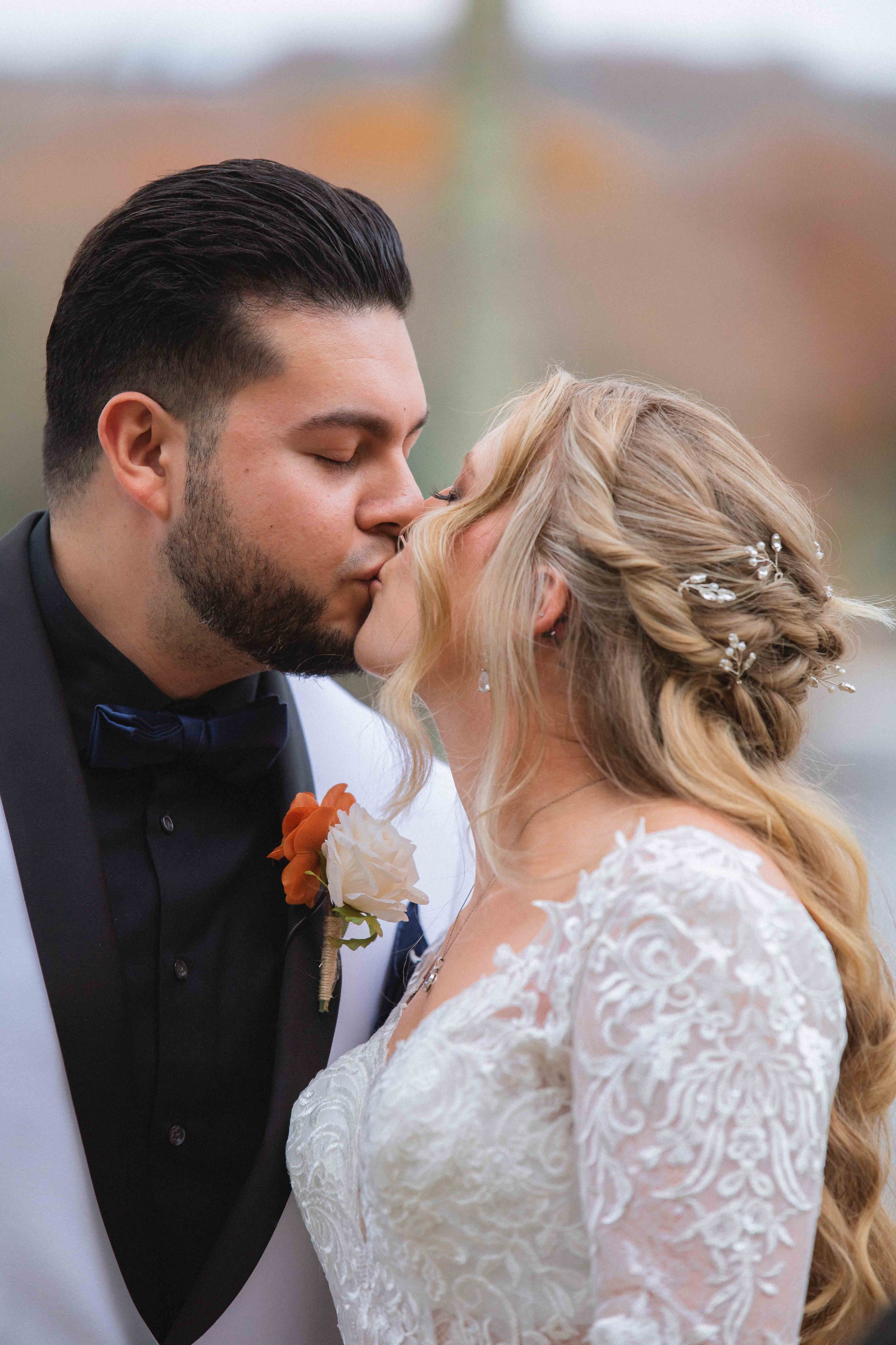 Groom and bride kiss during first look at the waterview wedding venue in monroe ct