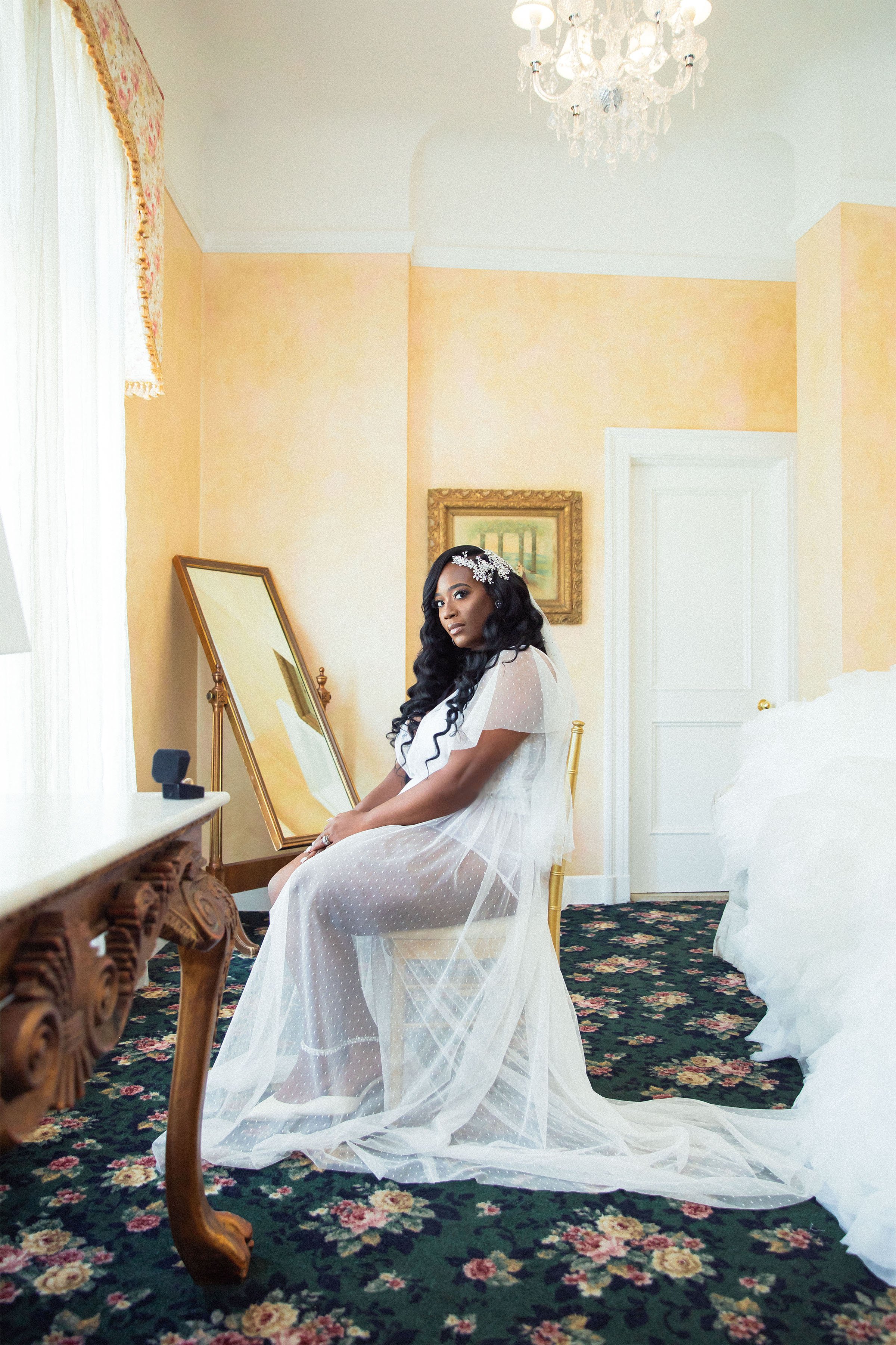 bride sitting in bridal suite getting ready before wedding ceremony at franklin plaza wedding venue in Troy NY