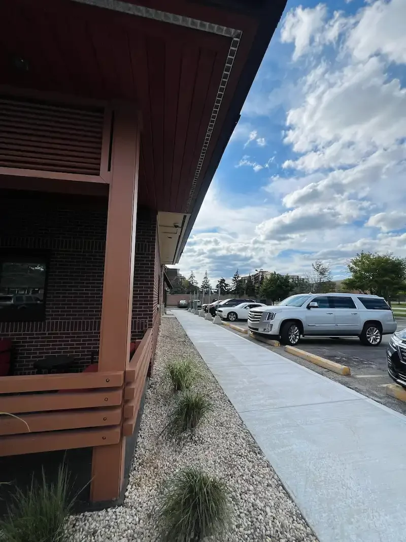 Commercial concrete parking lot and sidewalk installation for a business in Metro Detroit.