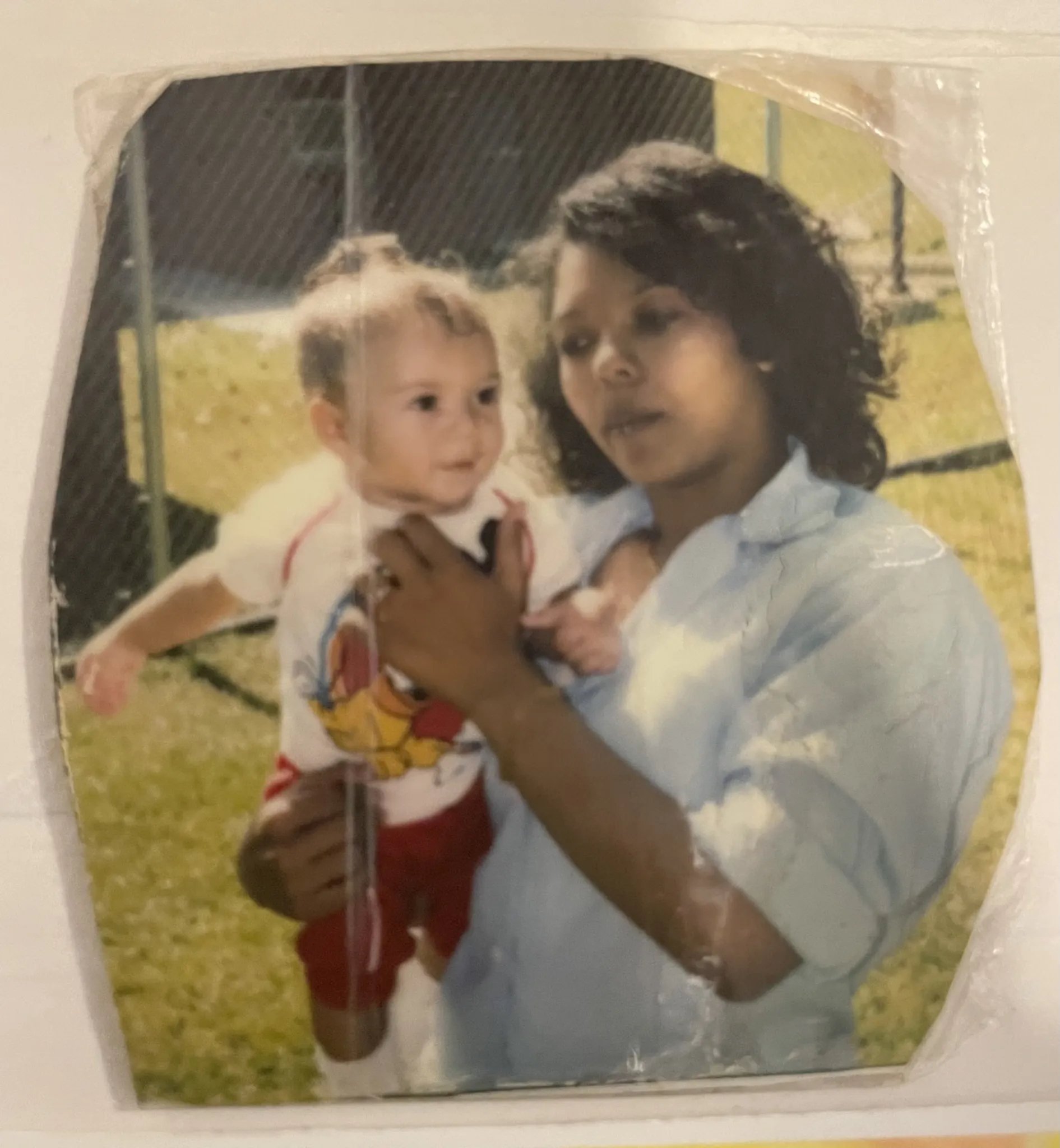 In a photo taken at prison, April holds her young son, Colt, in her arms.