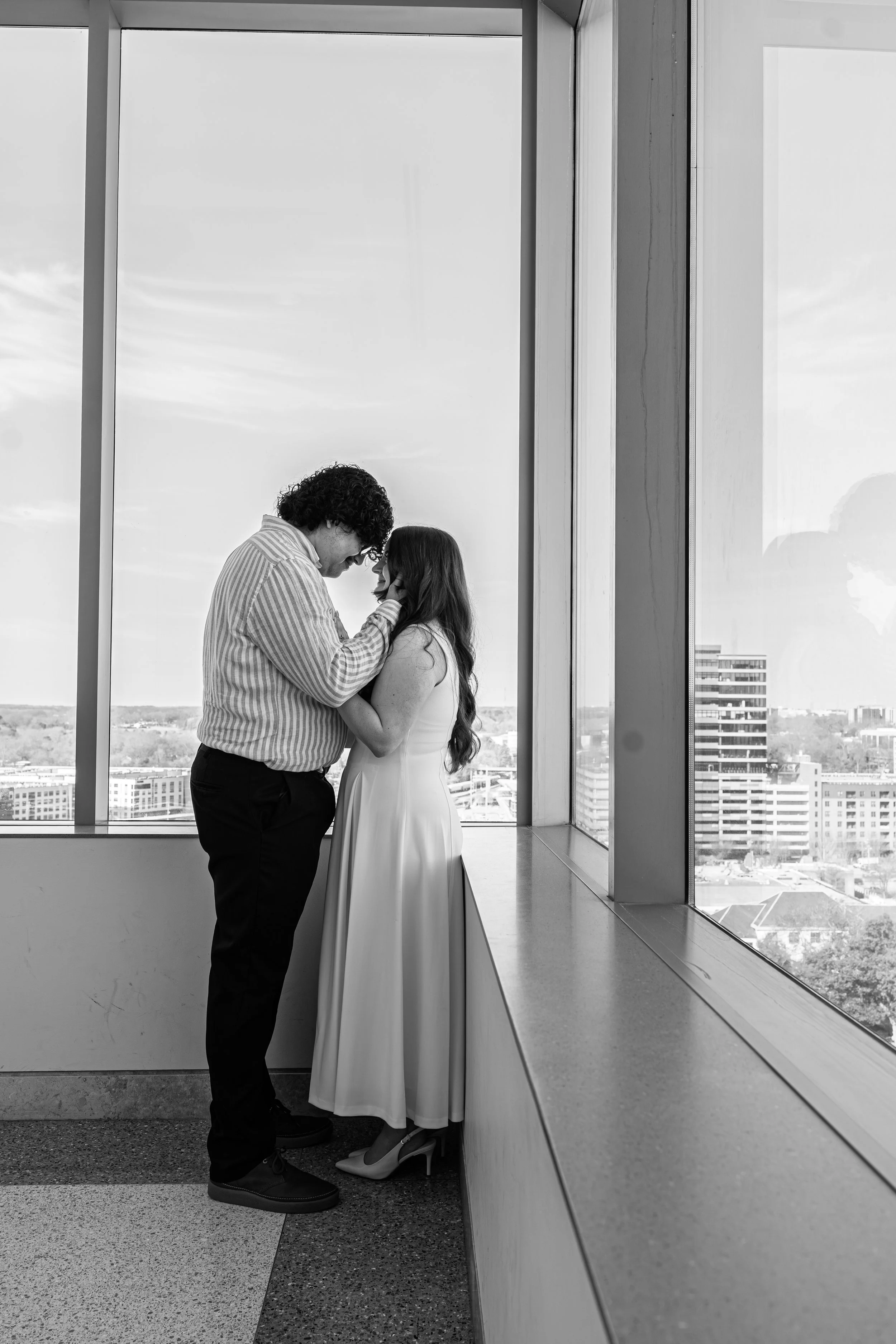wake-county-justice-center-civil-wedding-raleigh-nc-window-embrace-black-and-white.jpg