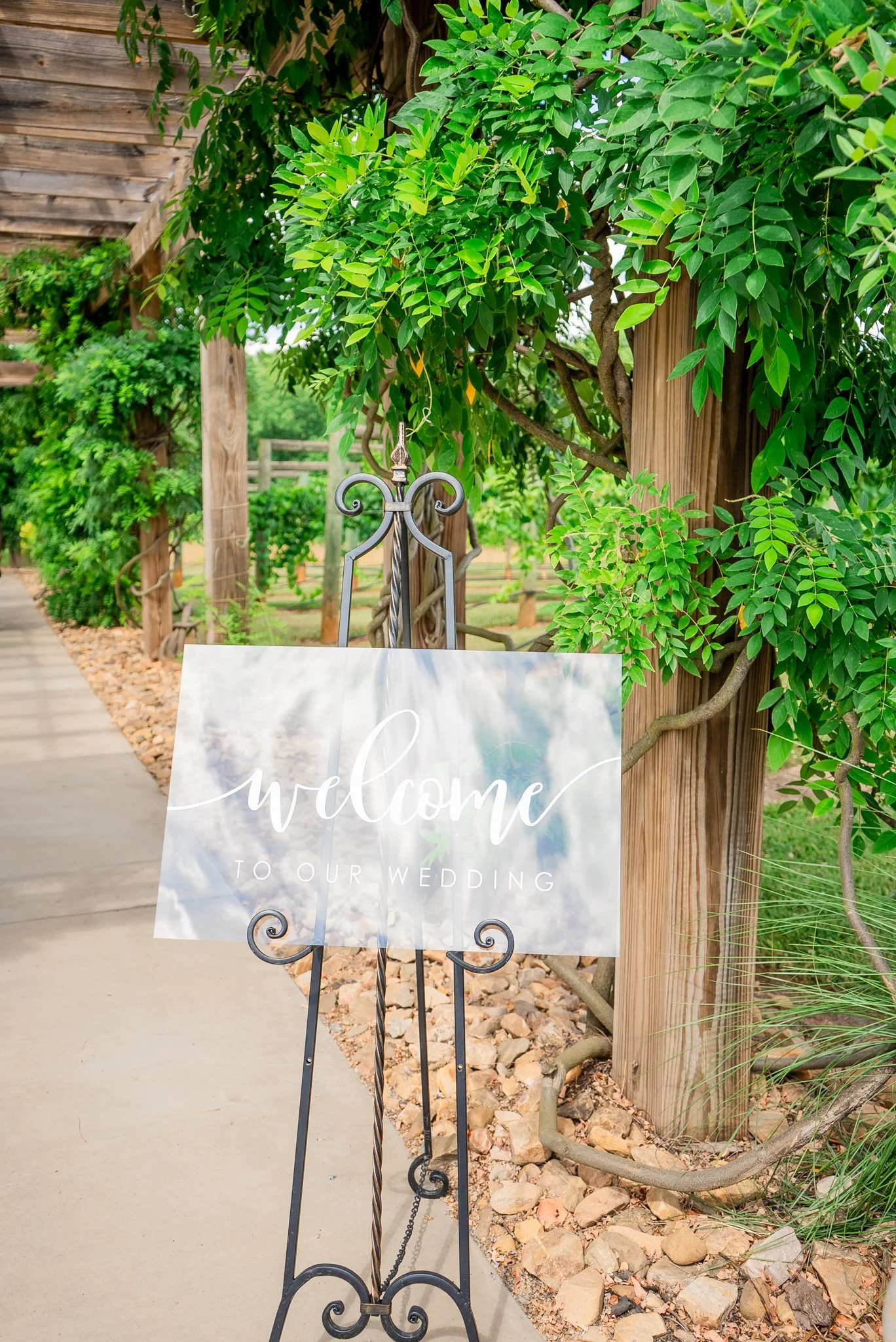 Welcome sign with greenery accents at Spinning Leaf vineyard wedding ceremony entrance
