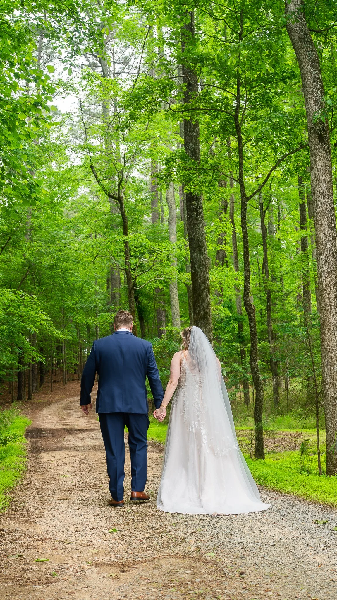 april-john-wedding-couple-walking-forest-mini-acre-farms-raleigh-nc.jpg
