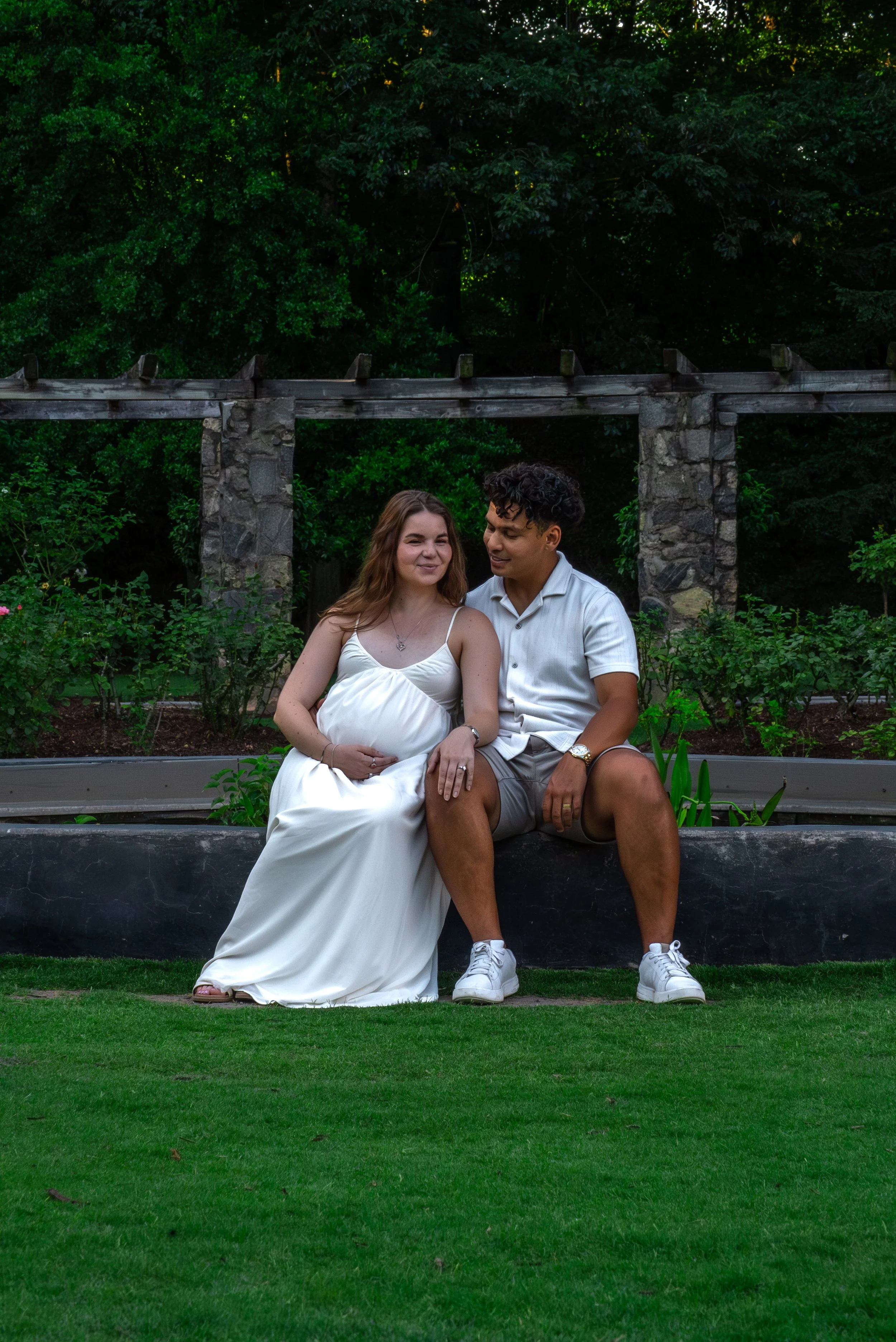 raleigh-rose-garden-raleigh-nc-maternity-session-sitting-together.jpg