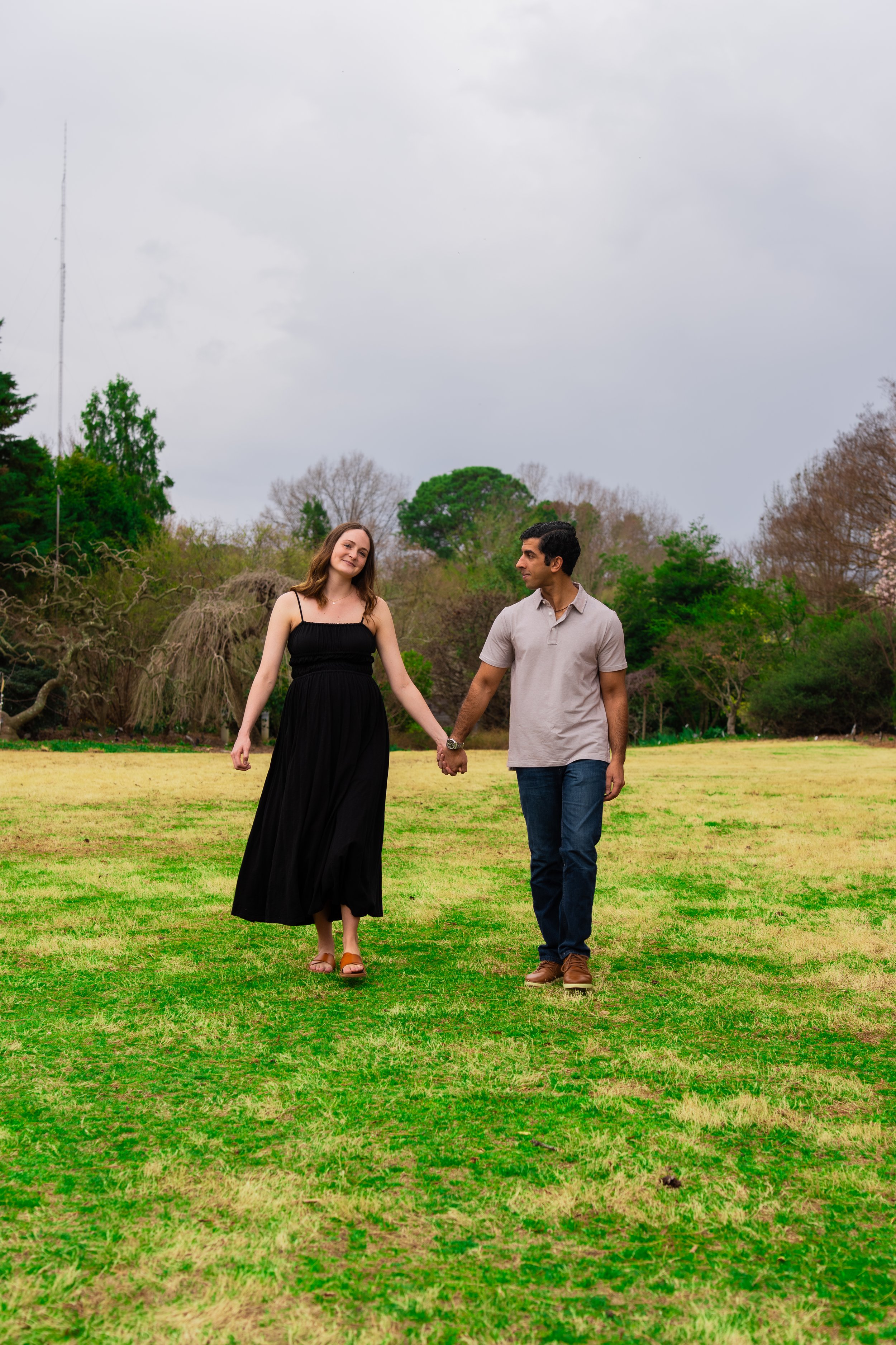 jc-raulston-arboretum-raleigh-nc-maternity-session-field-holding-hands.jpg