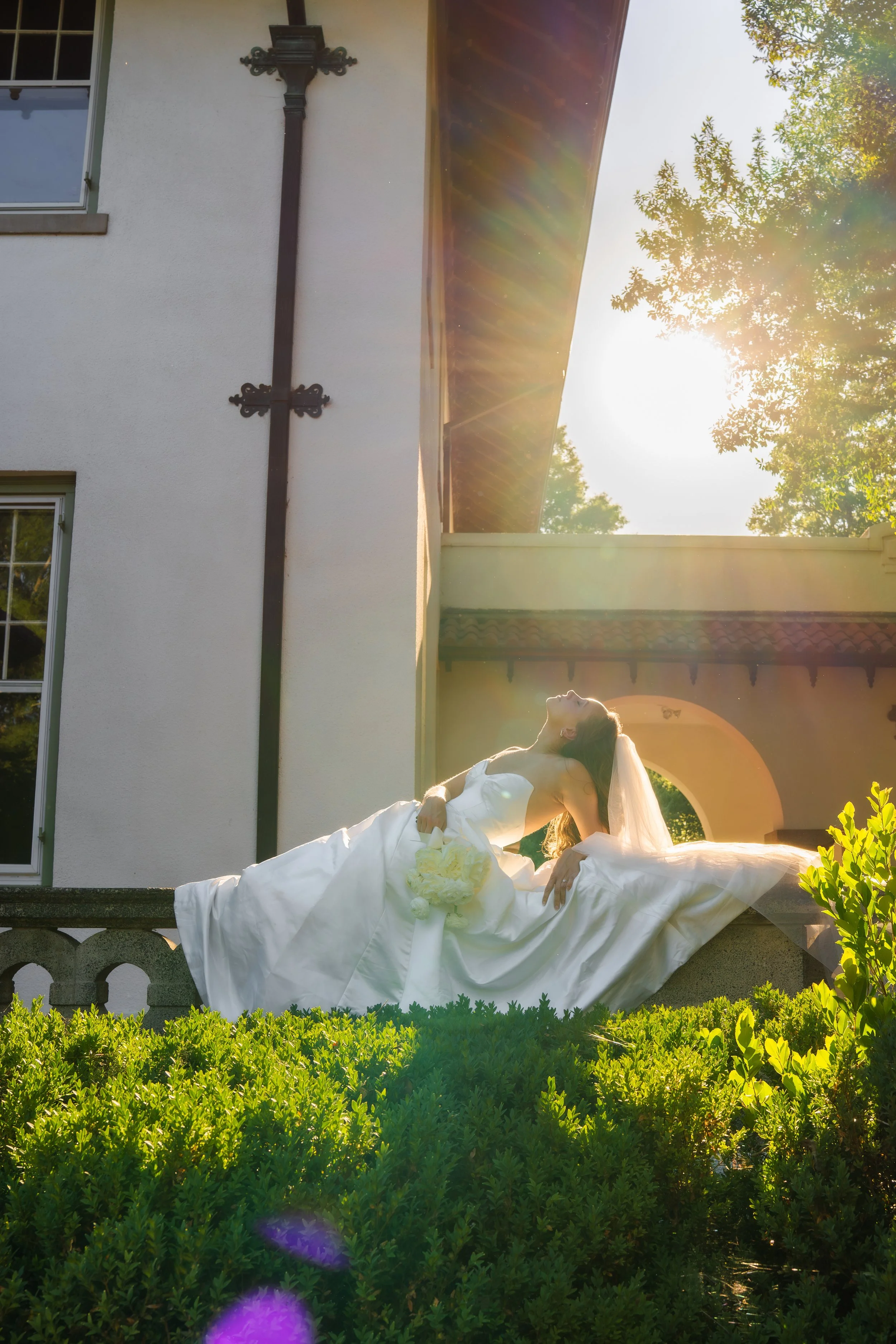 Elegant bride reclining outdoors at sunset during a luxury North Carolina wedding captured by KZK Visuals.