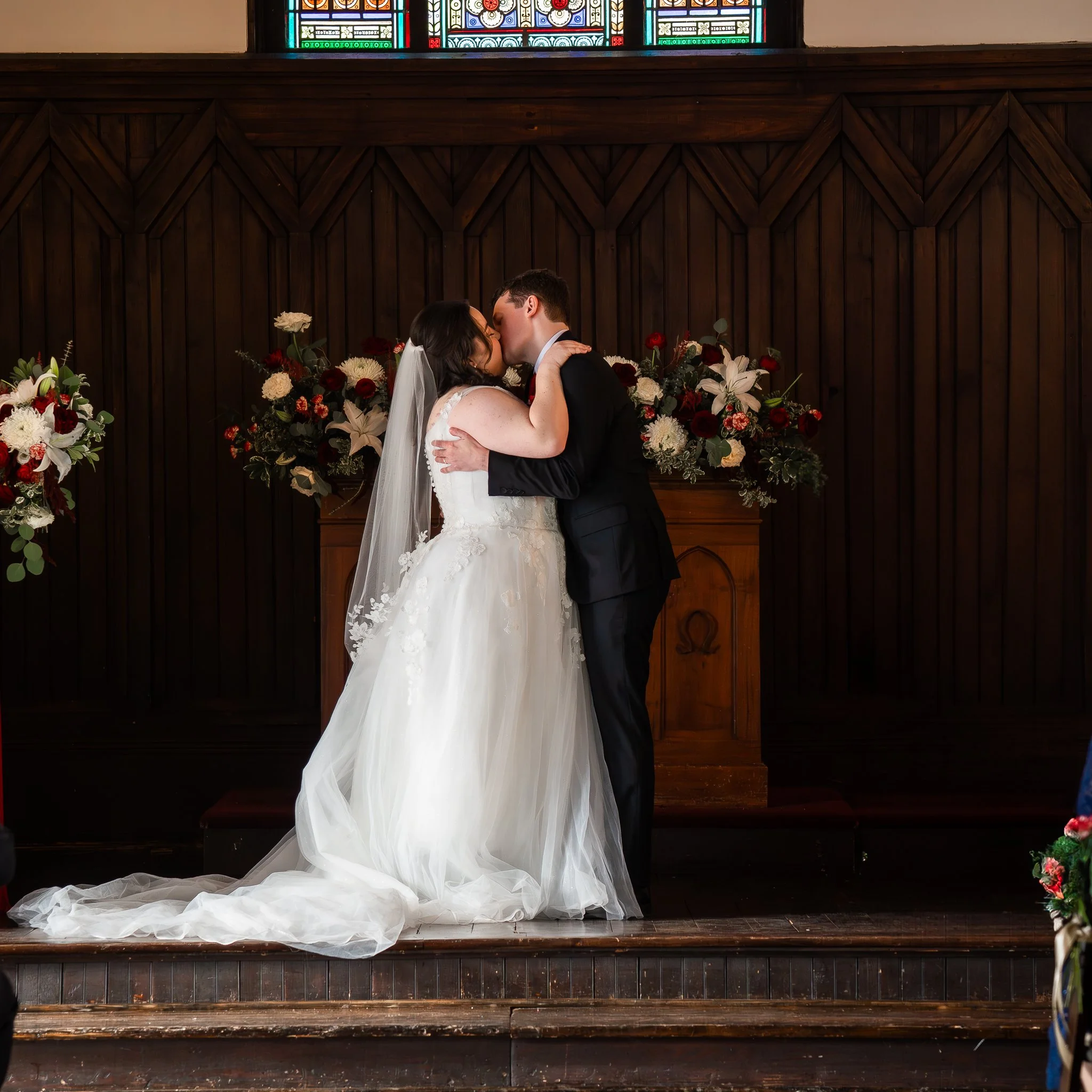 all-saints-chapel-raleigh-nc-wedding-first-kiss.jpg