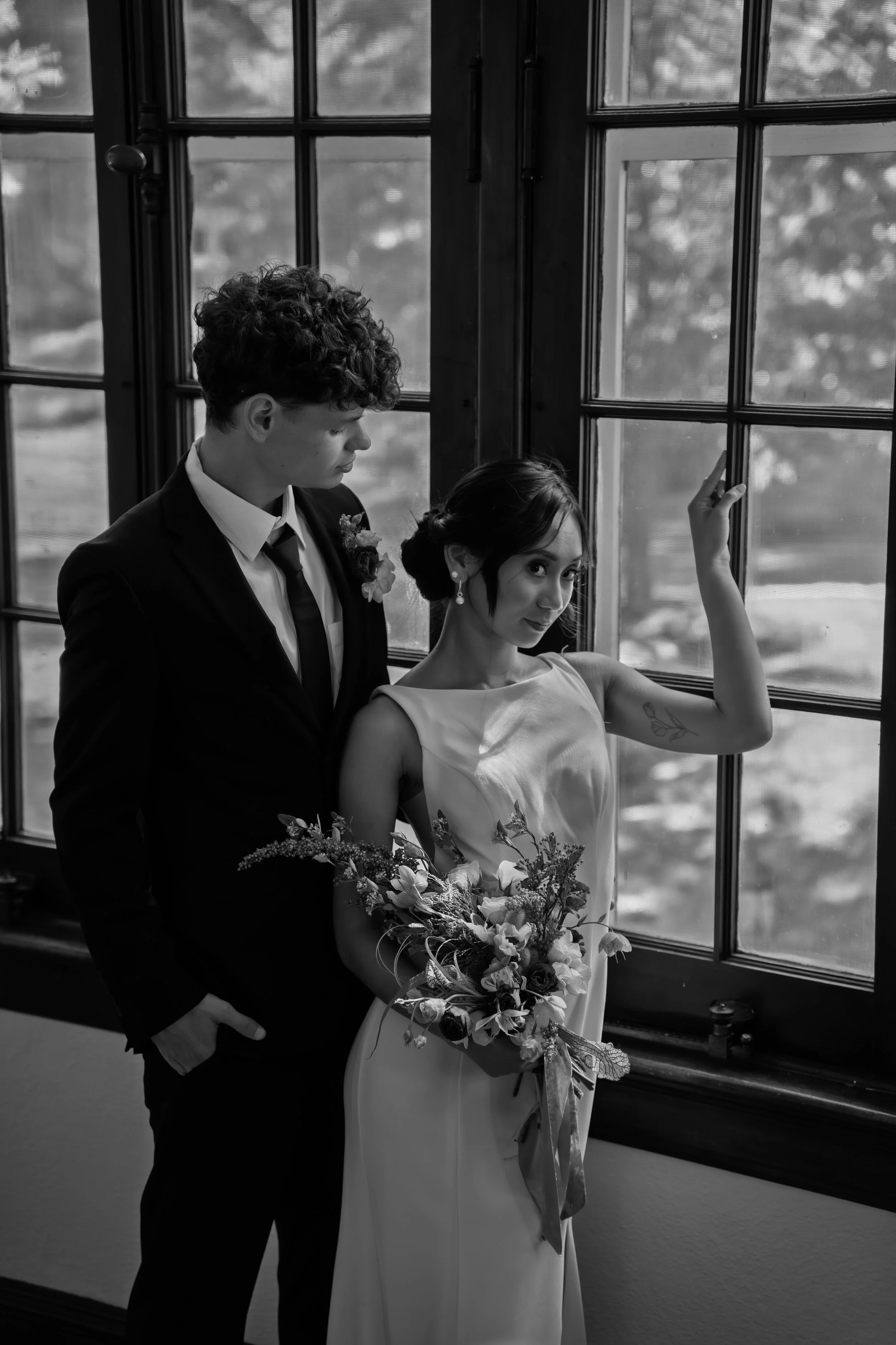 hill-house-durham-nc-wedding-black-and-white-window-embrace.jpg