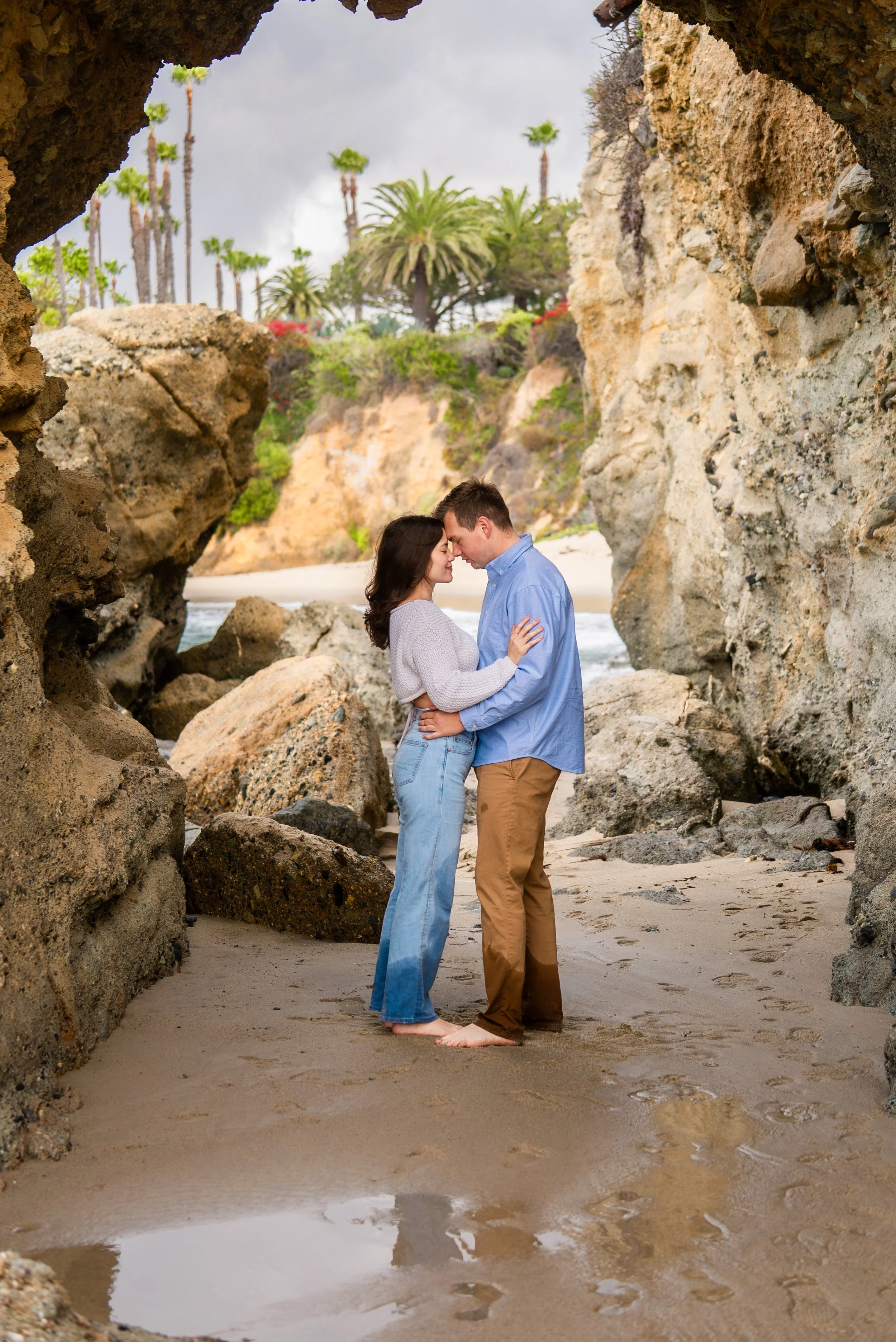laguna-beach-couples-photographer-rock-arch-embrace.jpg