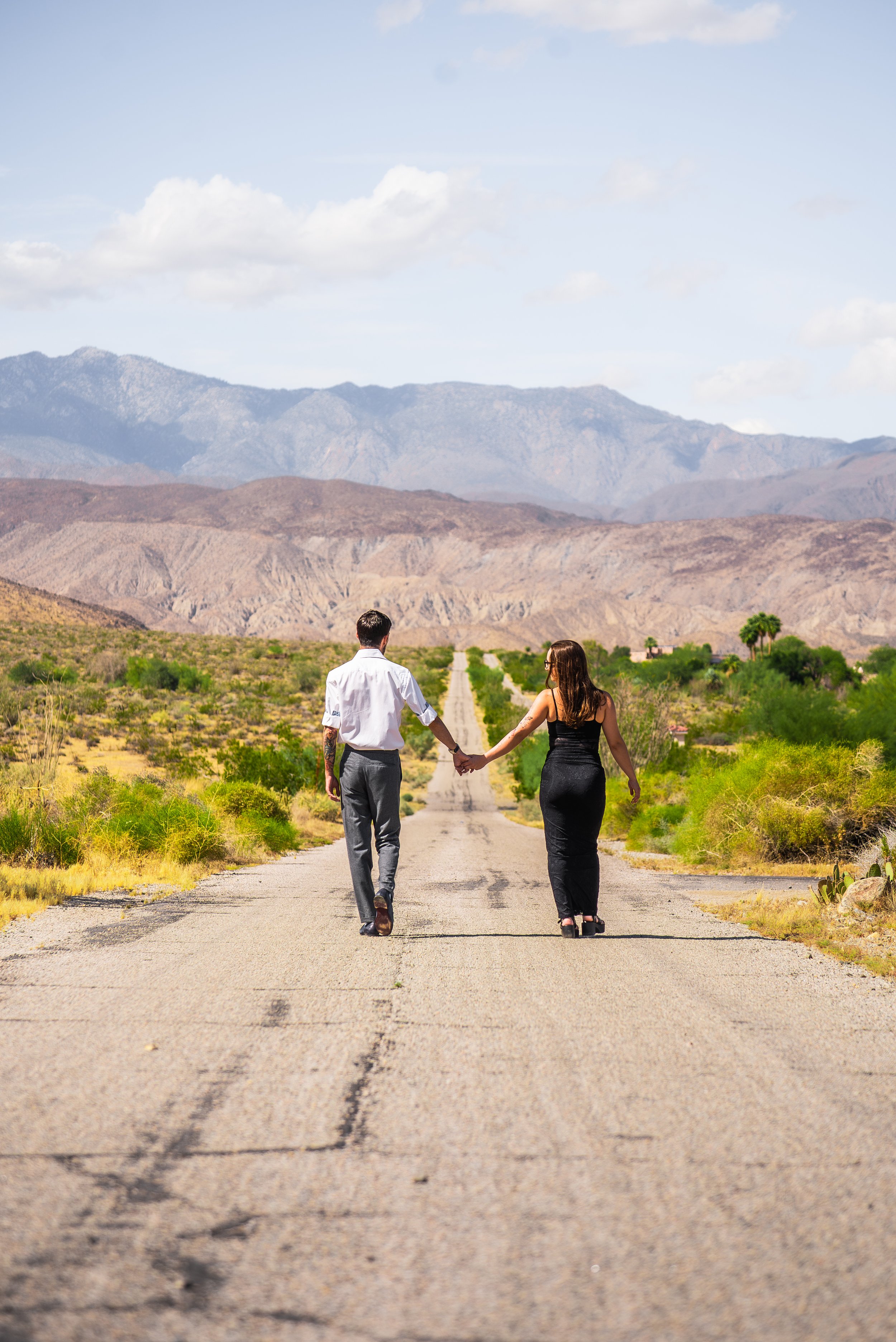 anza-borrego-couples-photographer-walking-away-road.jpg