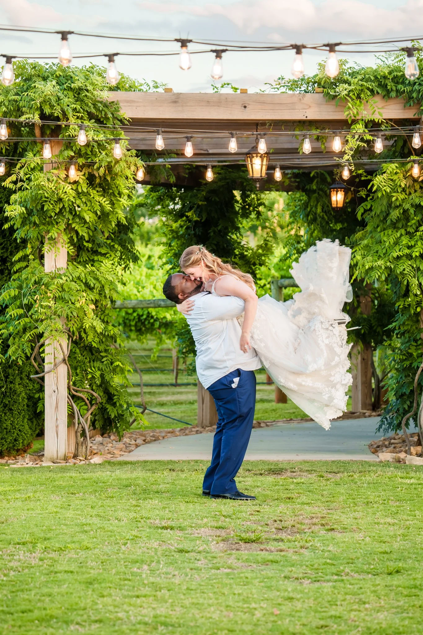 Bride and groom Rebecca and JaNathan sharing a quiet moment under the pergola at Spinning Leaf at the Vineyard in Shelby, NC.