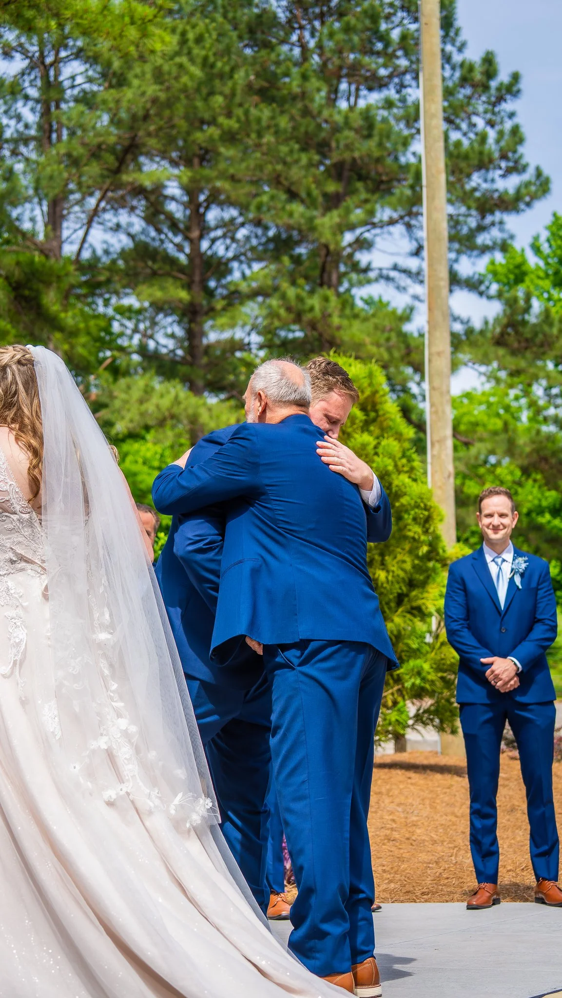 april-john-wedding-ceremony-family-embrace-mini-acre-farms-raleigh-nc.jpg