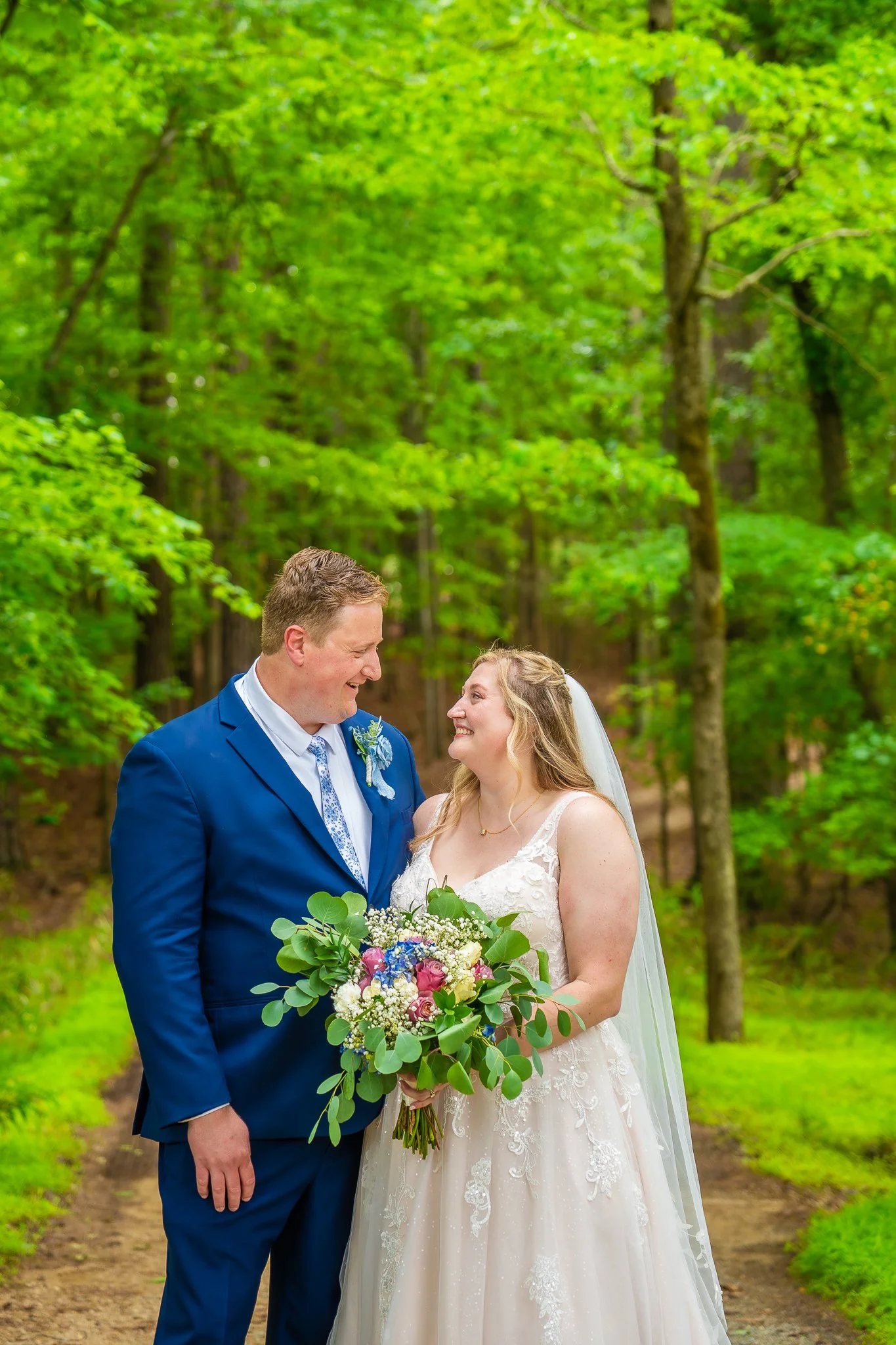 april-john-wedding-couple-portrait-wooded-path-mini-acre-farms-raleigh-nc.jpg