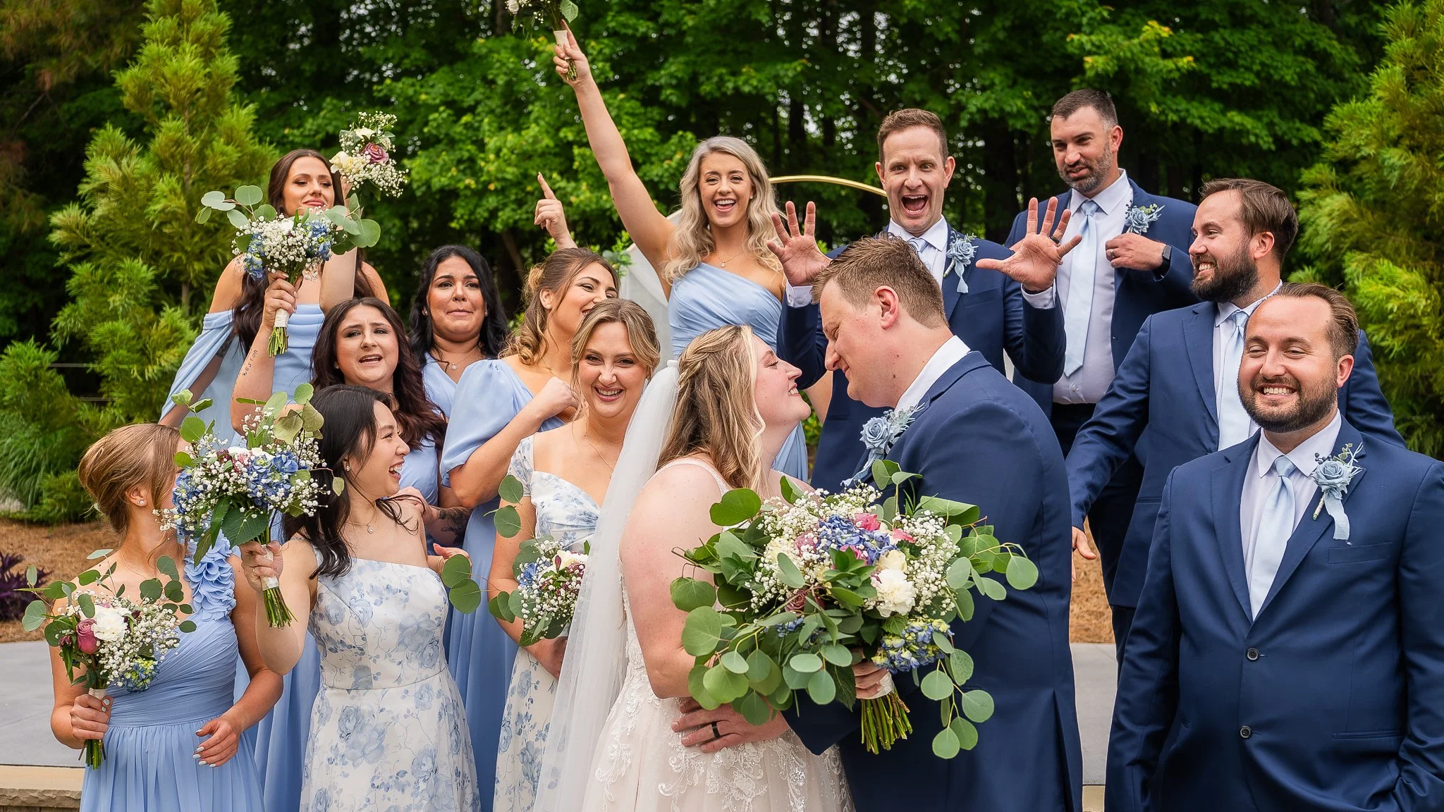 april-john-wedding-cheering-with-bridal-party-mini-acre-farms-raleigh-nc.jpg
